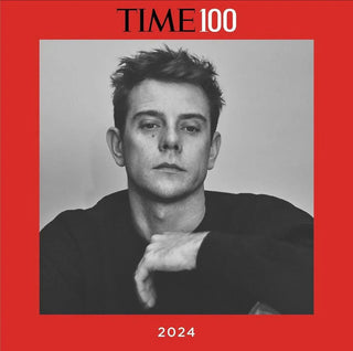 2024 TIME100 cover featuring a black and white portrait of a serious man with tousled hair on a red background