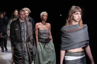 Models walking runway in avant-garde Magliano fashion show with layered, muted-toned outfits.