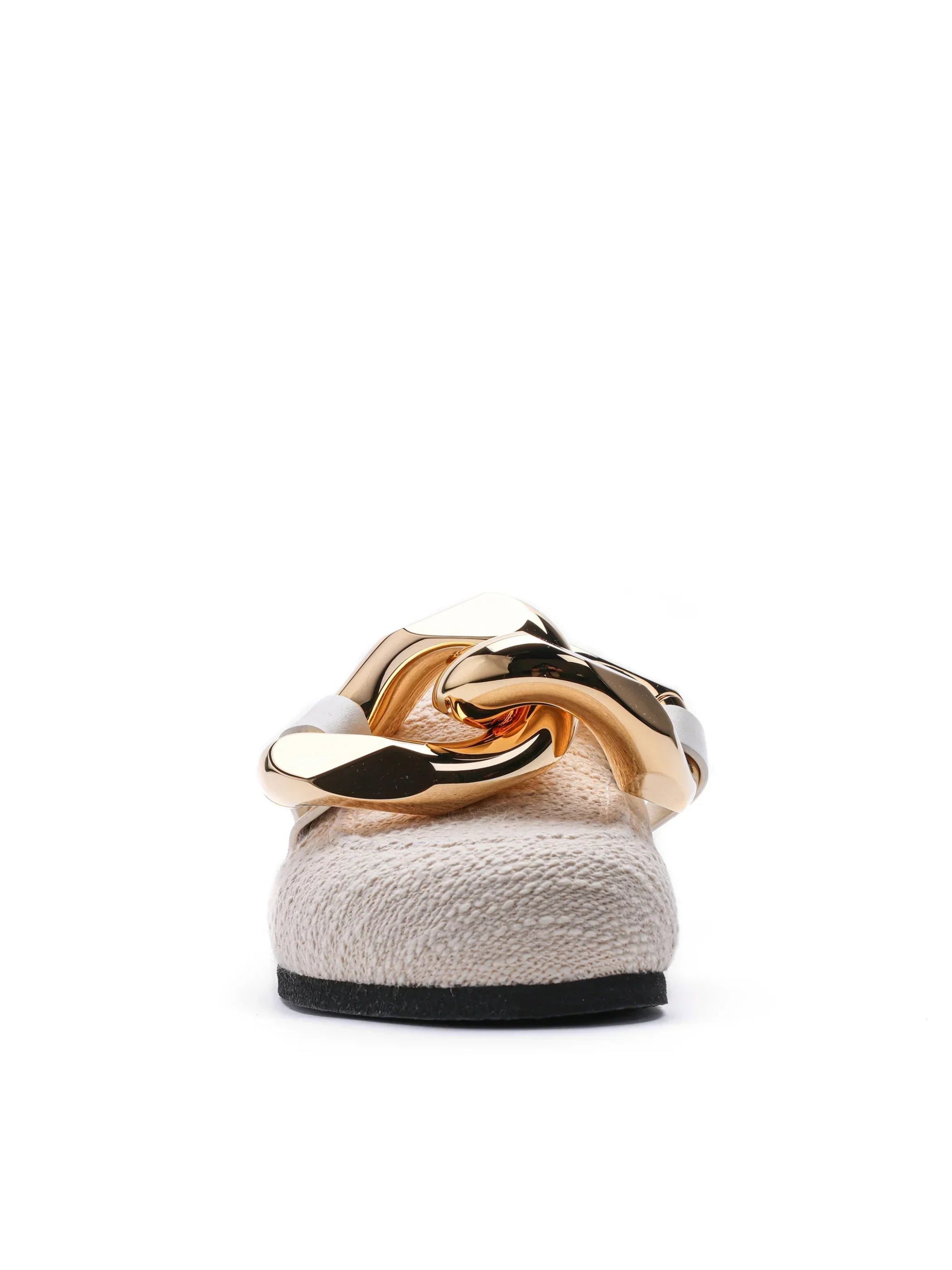 Close-up of beige flat shoe with chunky gold chain detail on white background