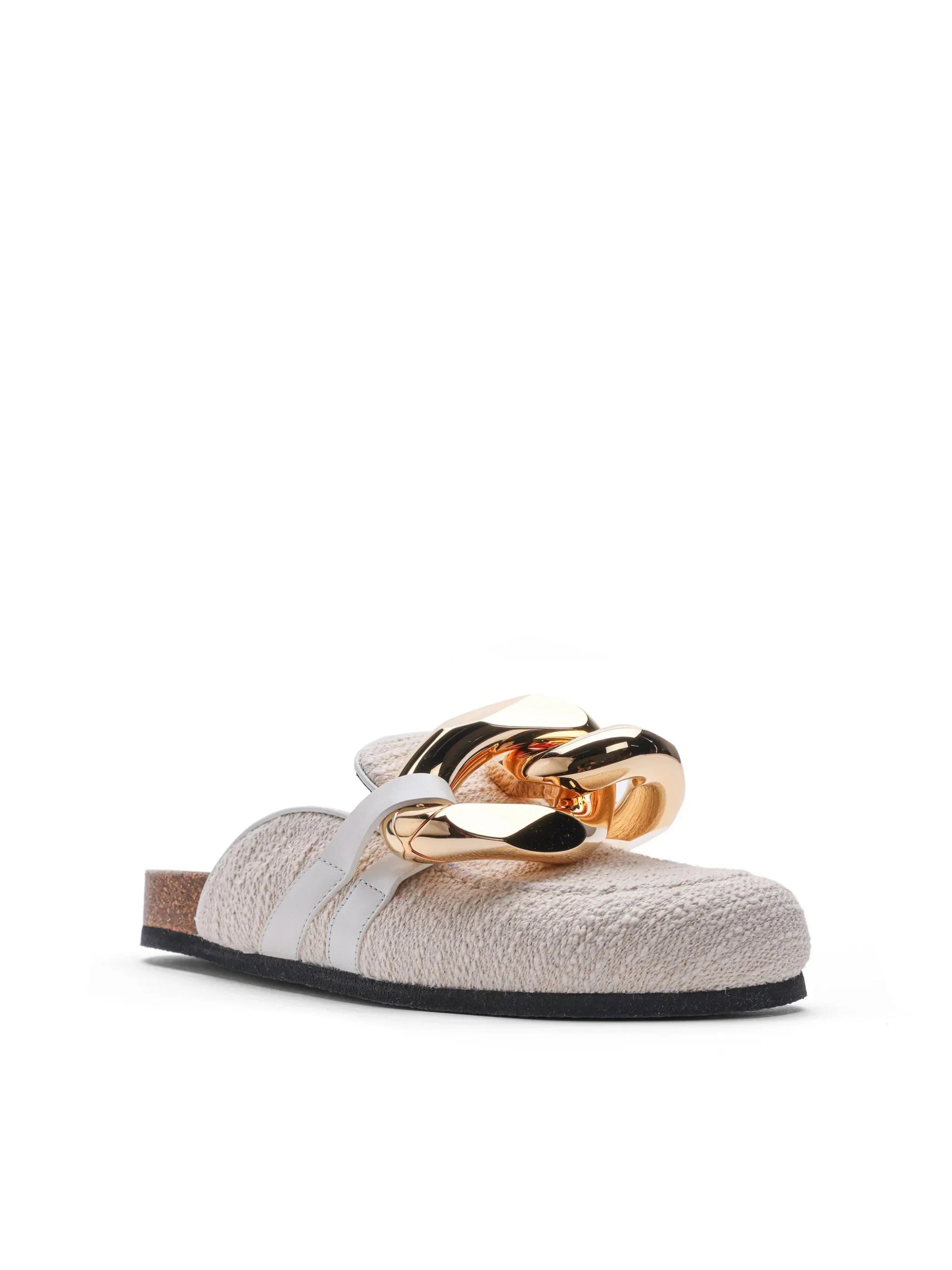 Beige slip-on mule shoe with textured fabric upper and oversized shiny gold chain detail
