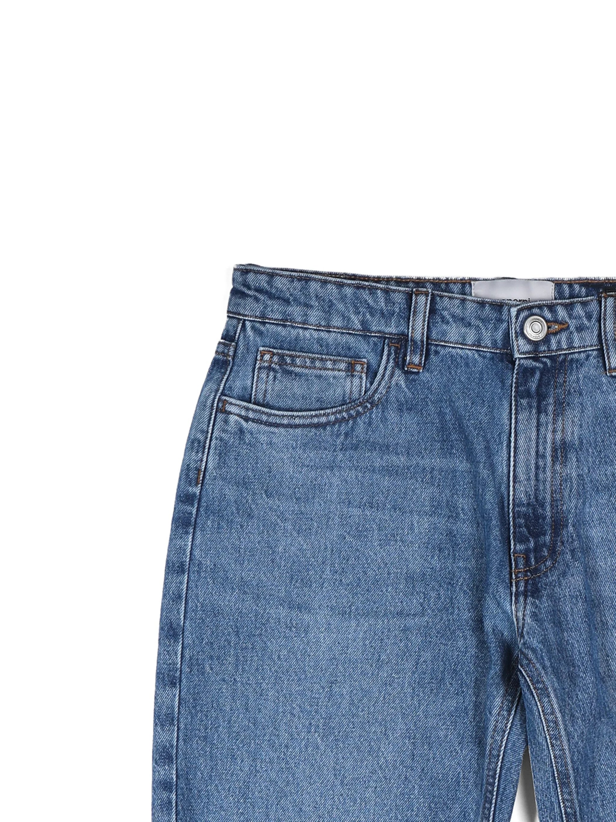 Close-up of classic blue denim jeans with front pockets, belt loops, and button fly