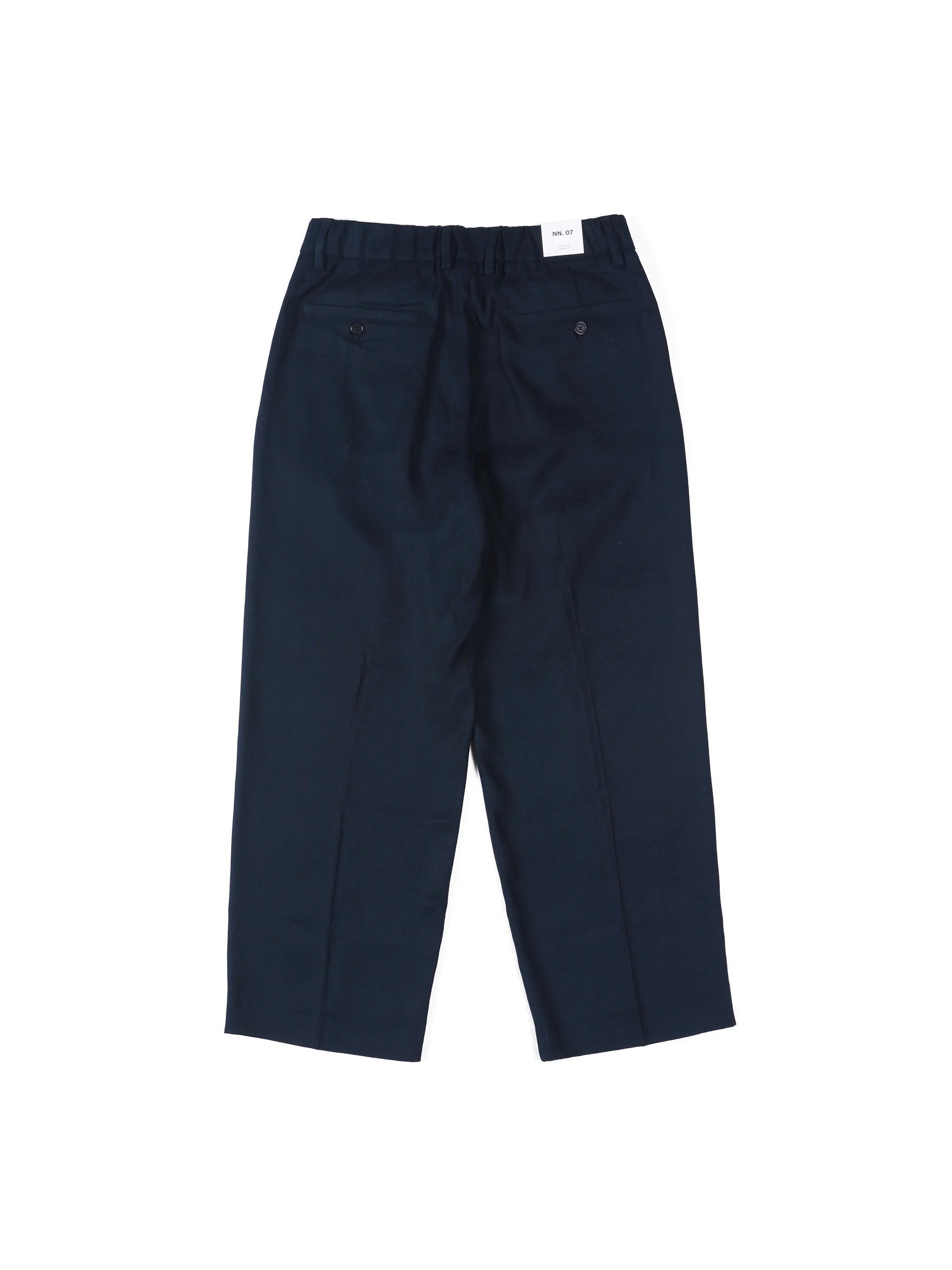 Back view of navy blue formal trousers with buttoned back pockets on white background