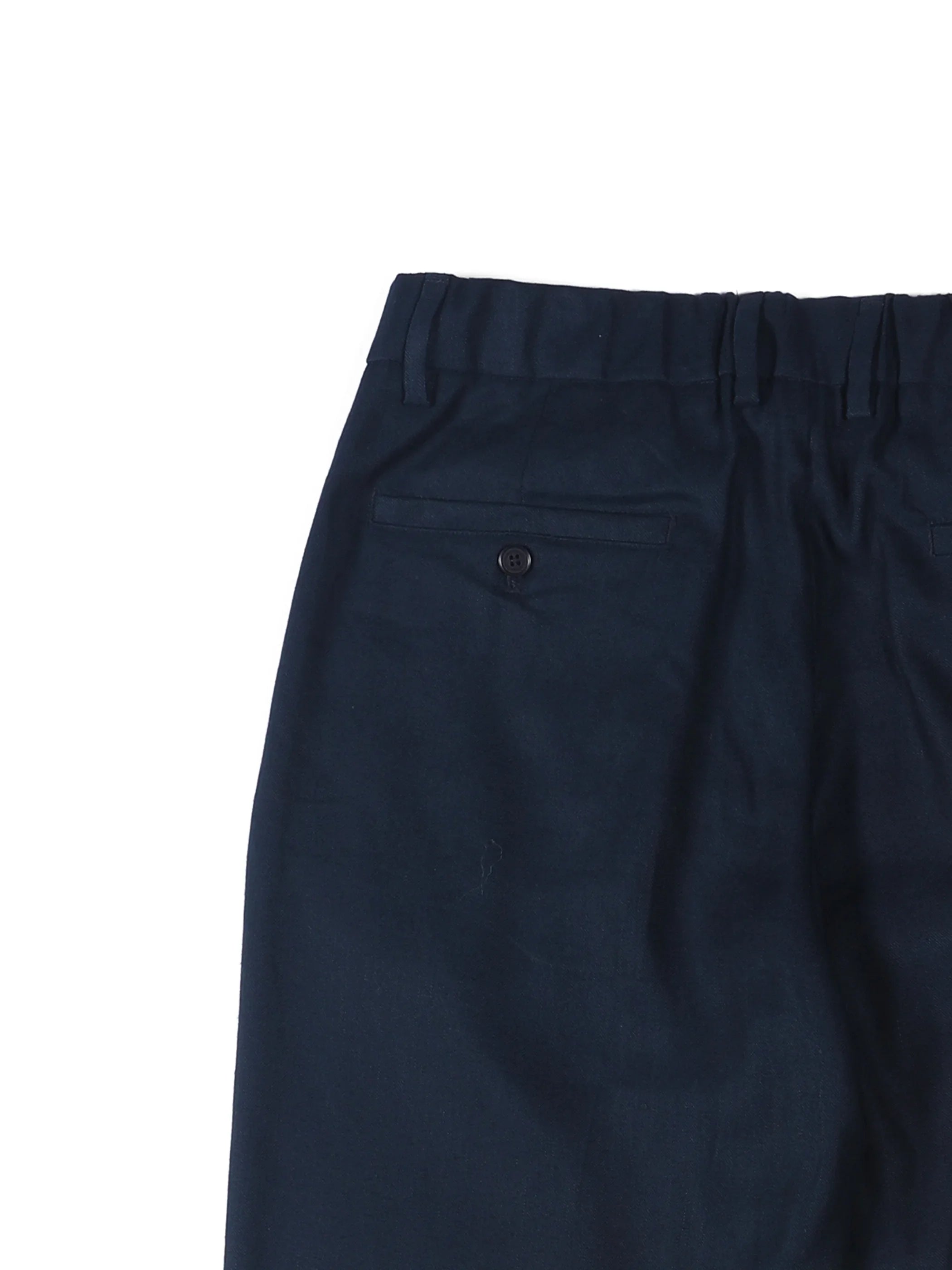 Back view of navy blue trousers with buttoned welt pockets and belt loops on white background