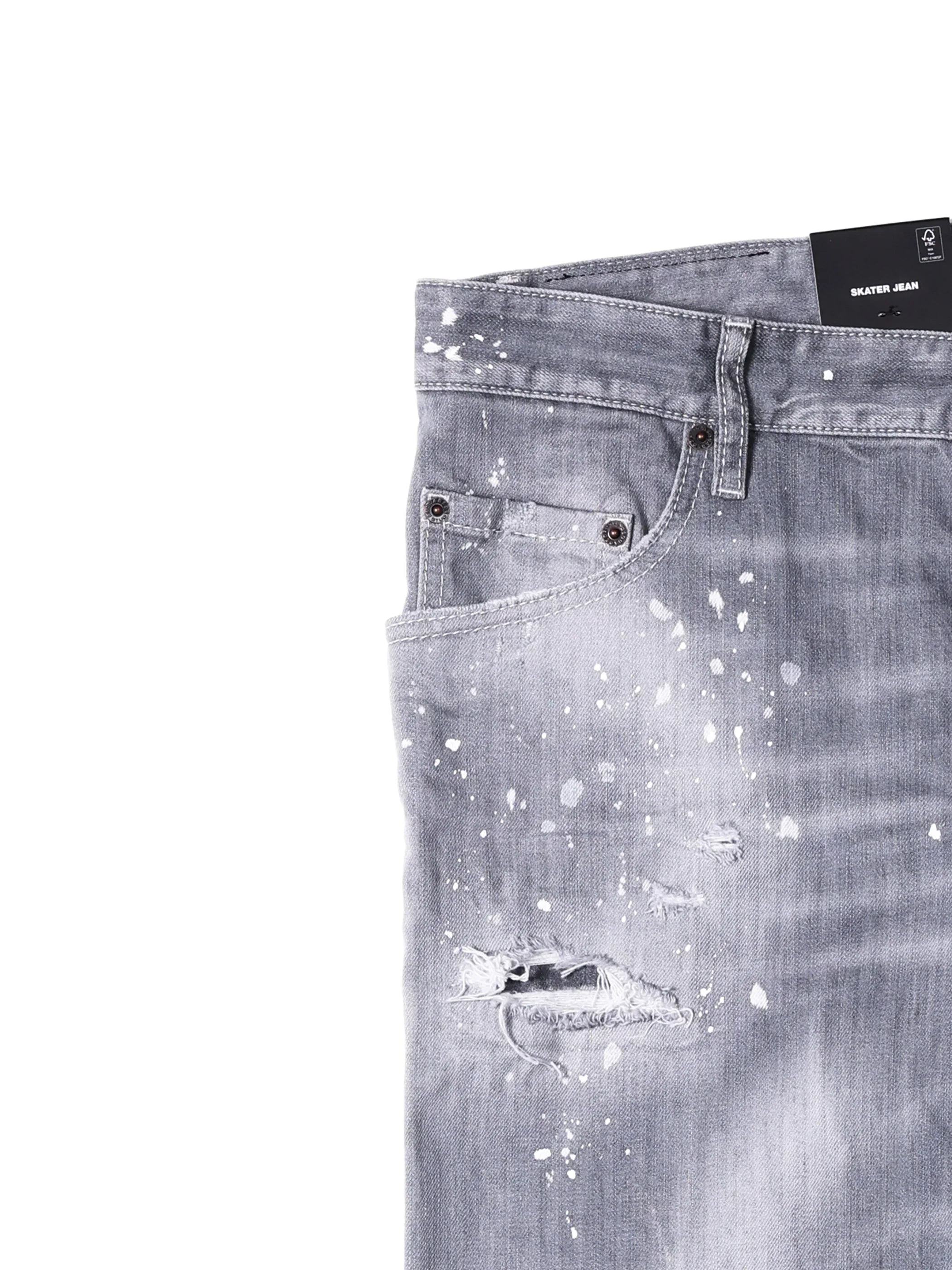 Close-up of gray distressed skater jeans with paint splatter and ripped hole detail
