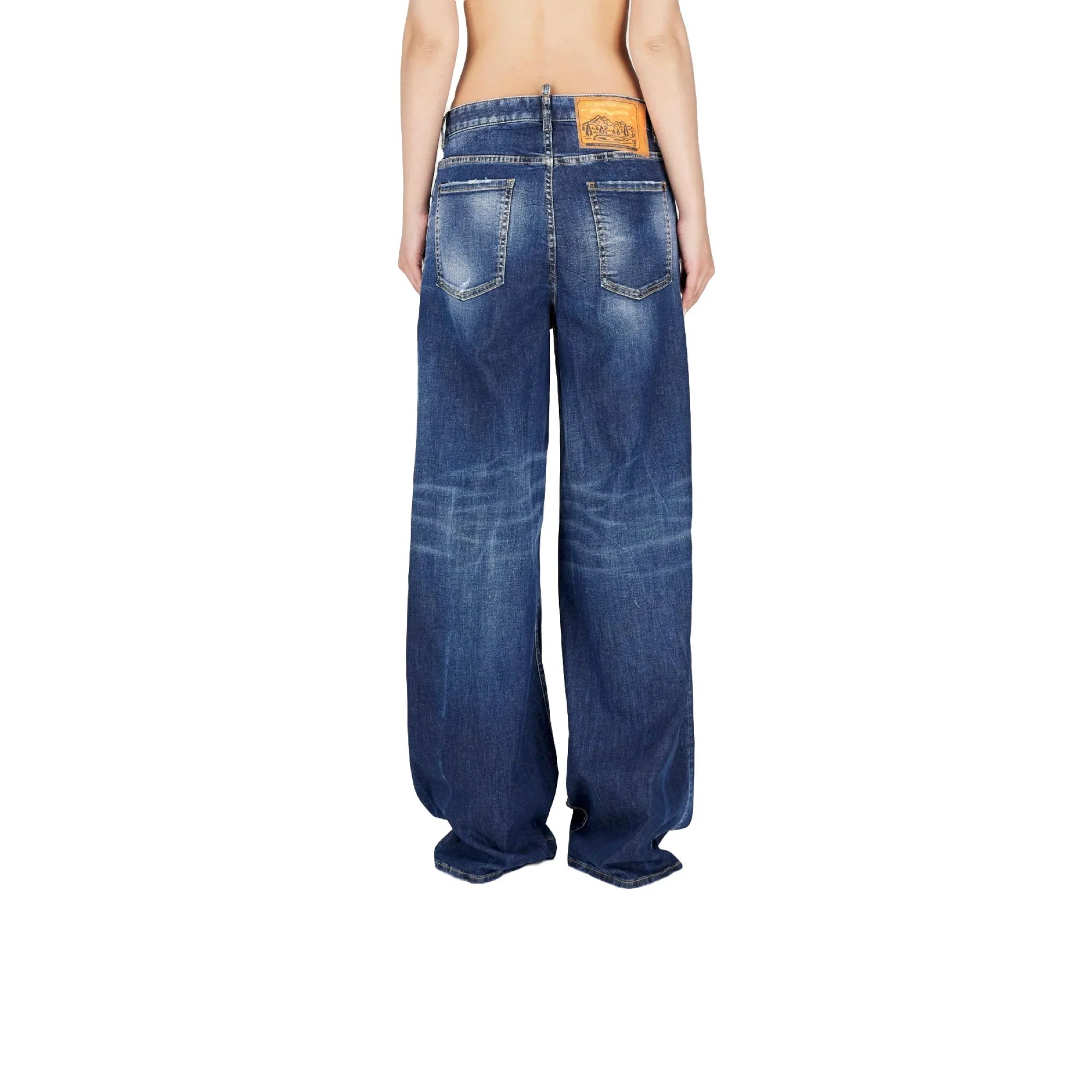 Back view of blue wide-leg denim jeans with faded details and leather brand patch