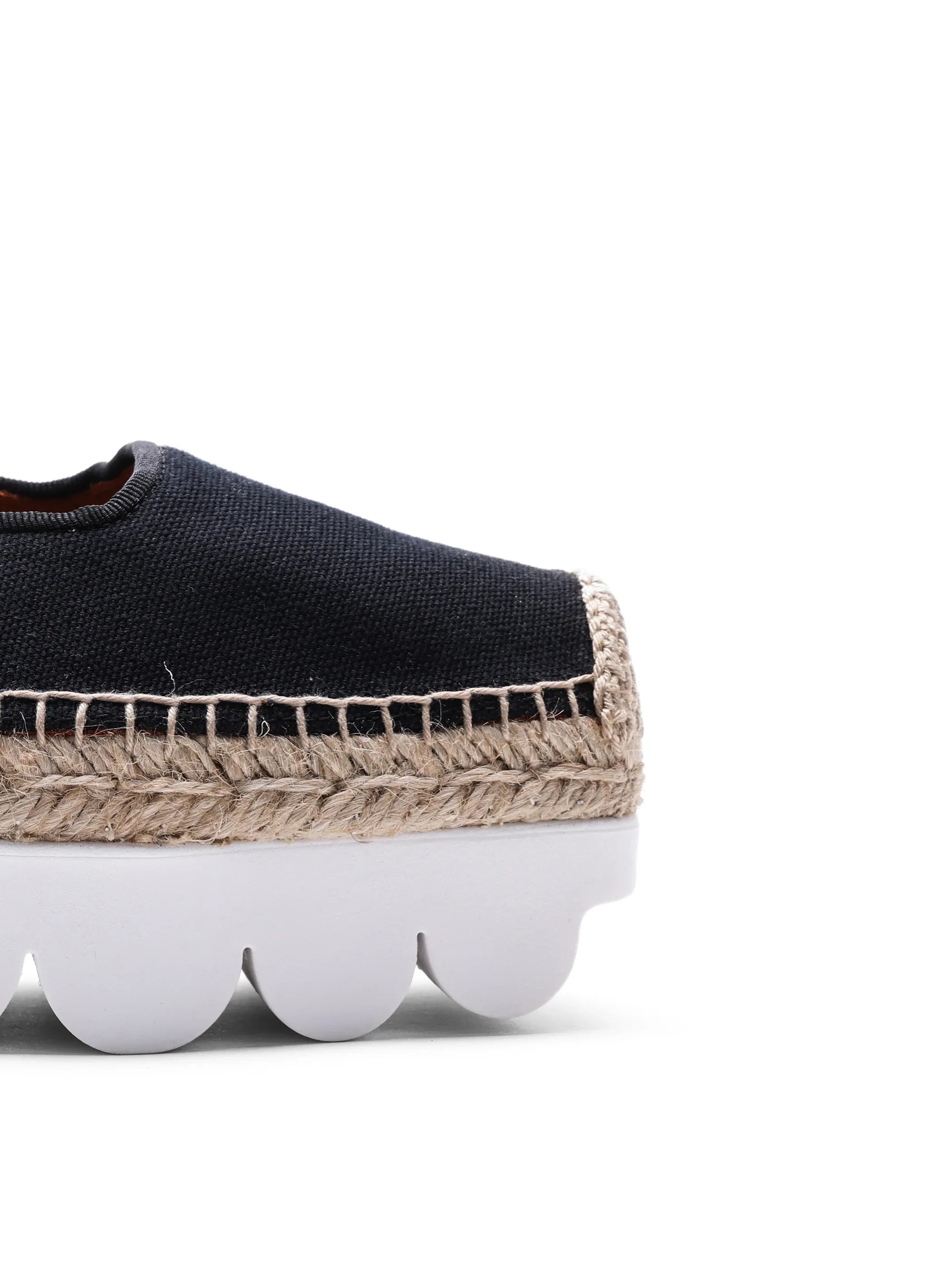 Black espadrille shoe with beige braided jute trim and scalloped white rubber sole