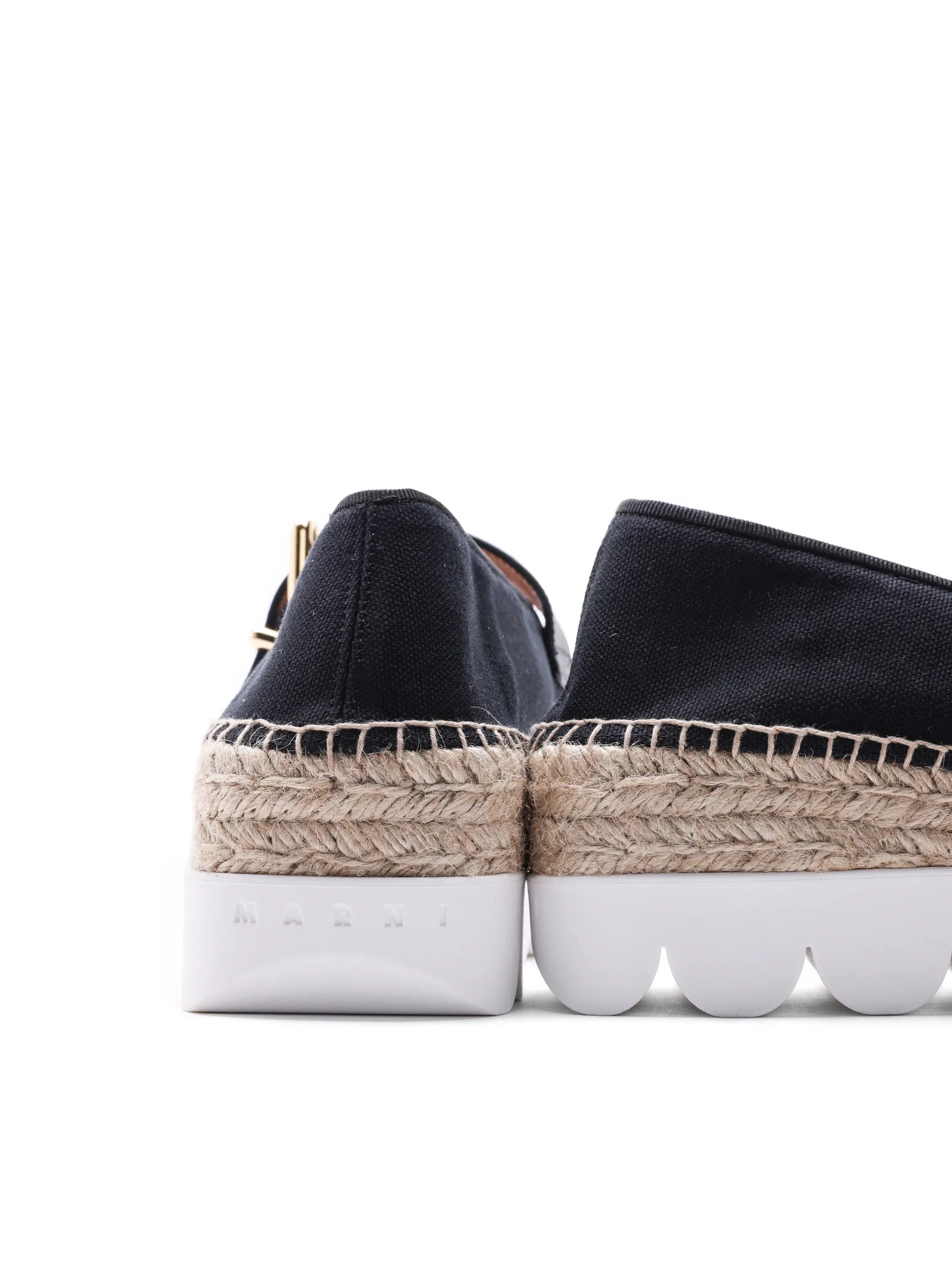 Back view of black canvas Marni espadrille shoes with braided jute midsole and white scalloped sole