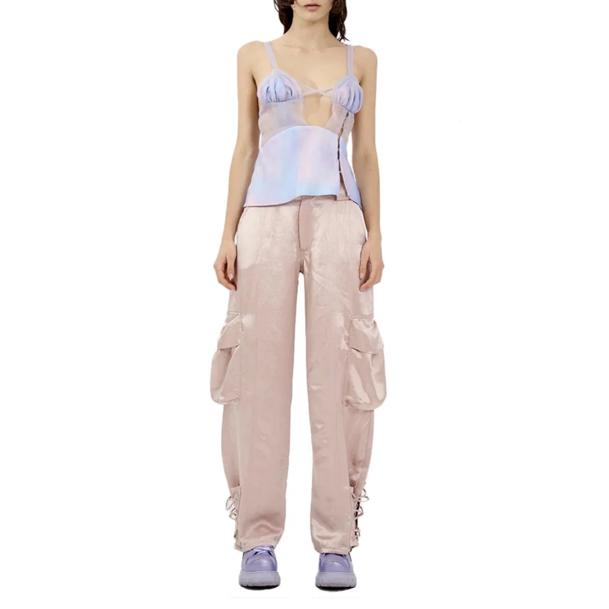 Model wearing lavender sheer camisole top and blush satin wide-leg cargo pants with purple sneakers