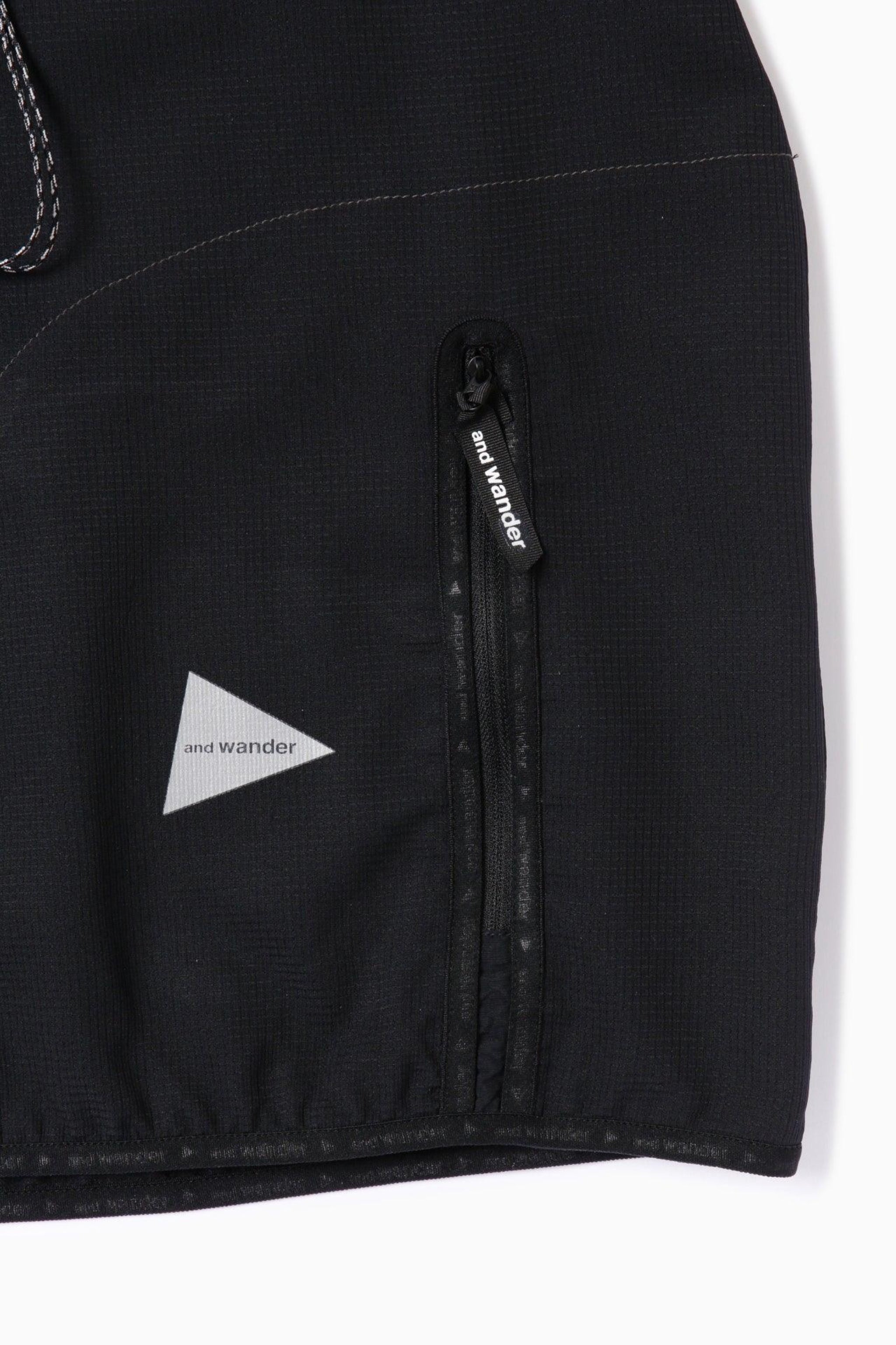 Black jacket with a zipper and visible brand logo on a white background