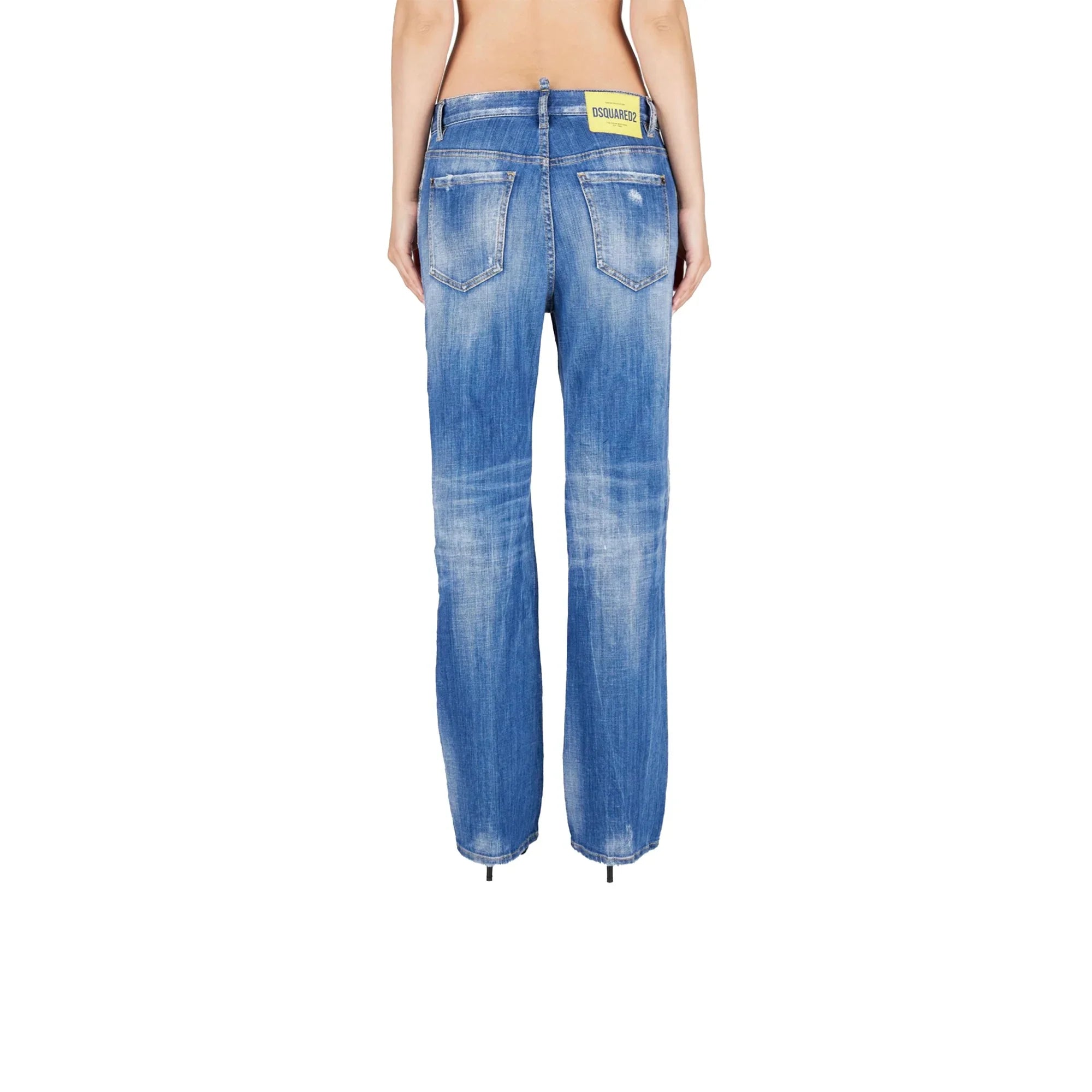 Back view of woman wearing blue distressed straight-leg jeans with DSQUARED2 label on waistband