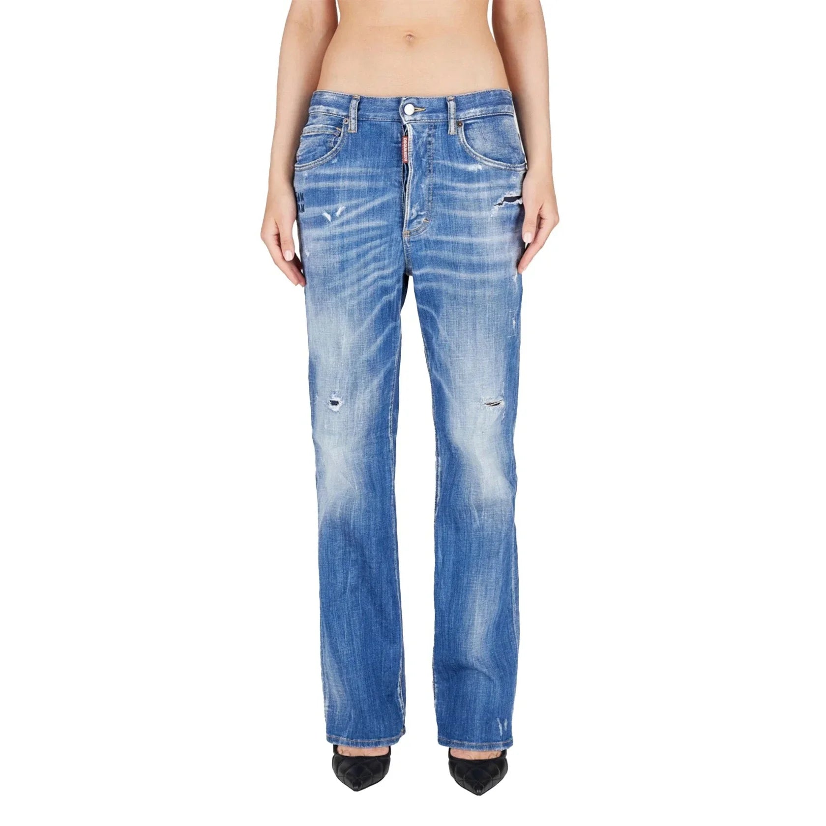 Front view of woman wearing distressed blue straight-leg denim jeans with fading and tears