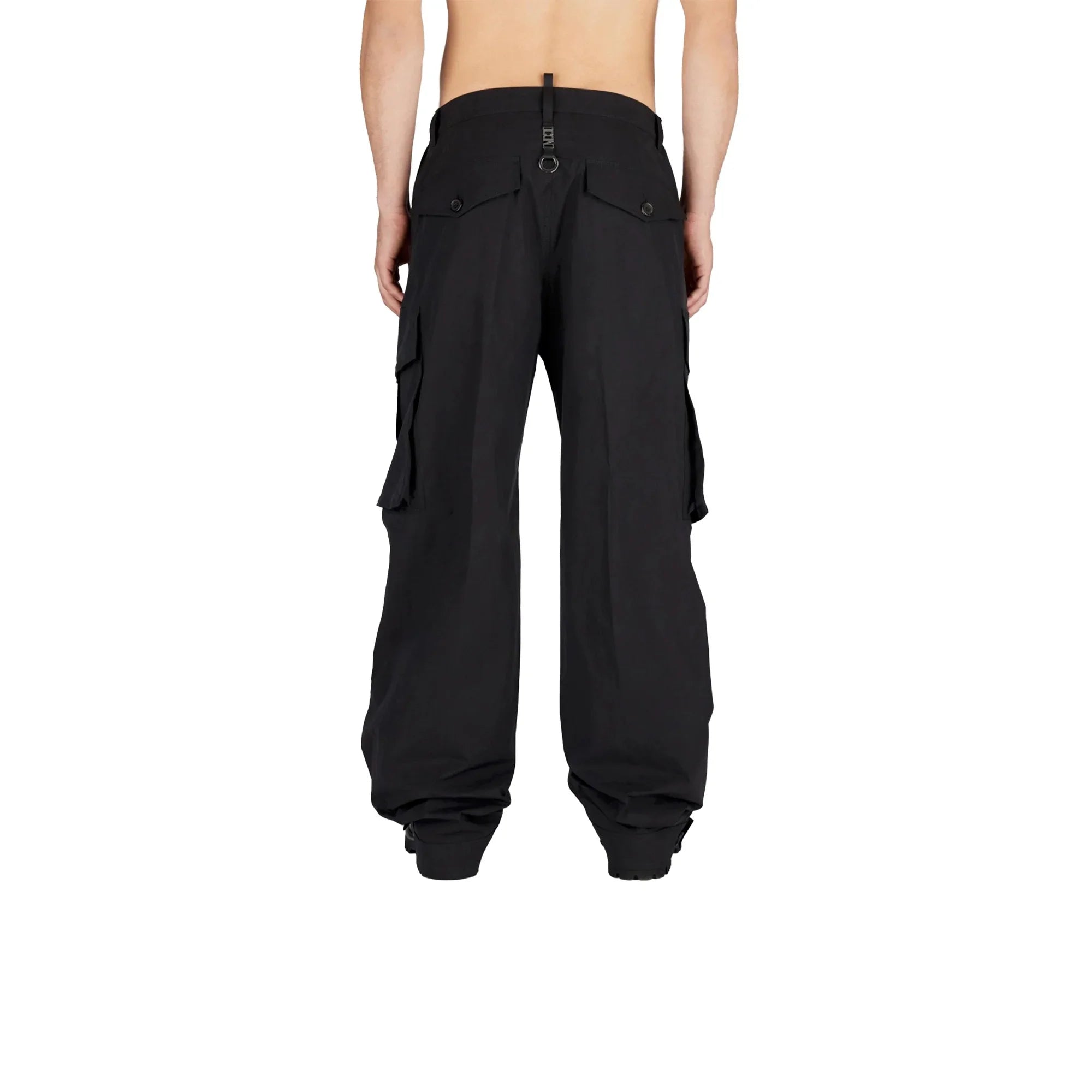 Back view of person wearing black cargo pants with multiple pockets and cinched hems on white background