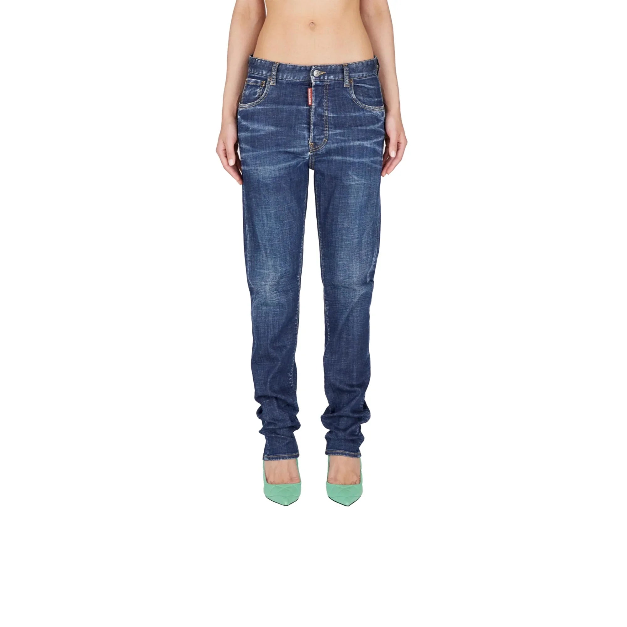 Woman wearing classic blue slim-fit jeans and green pointed heels against white background