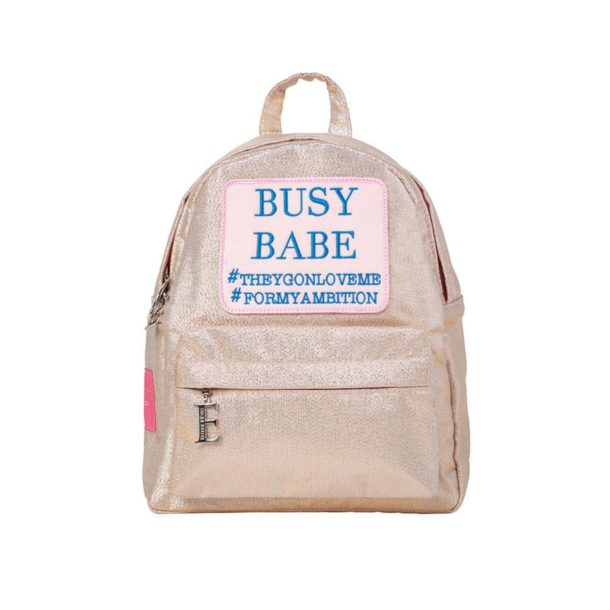 ENTRE REVES - Busy Babe Gold Mini beige backpack with a pink patch displaying text on a white background