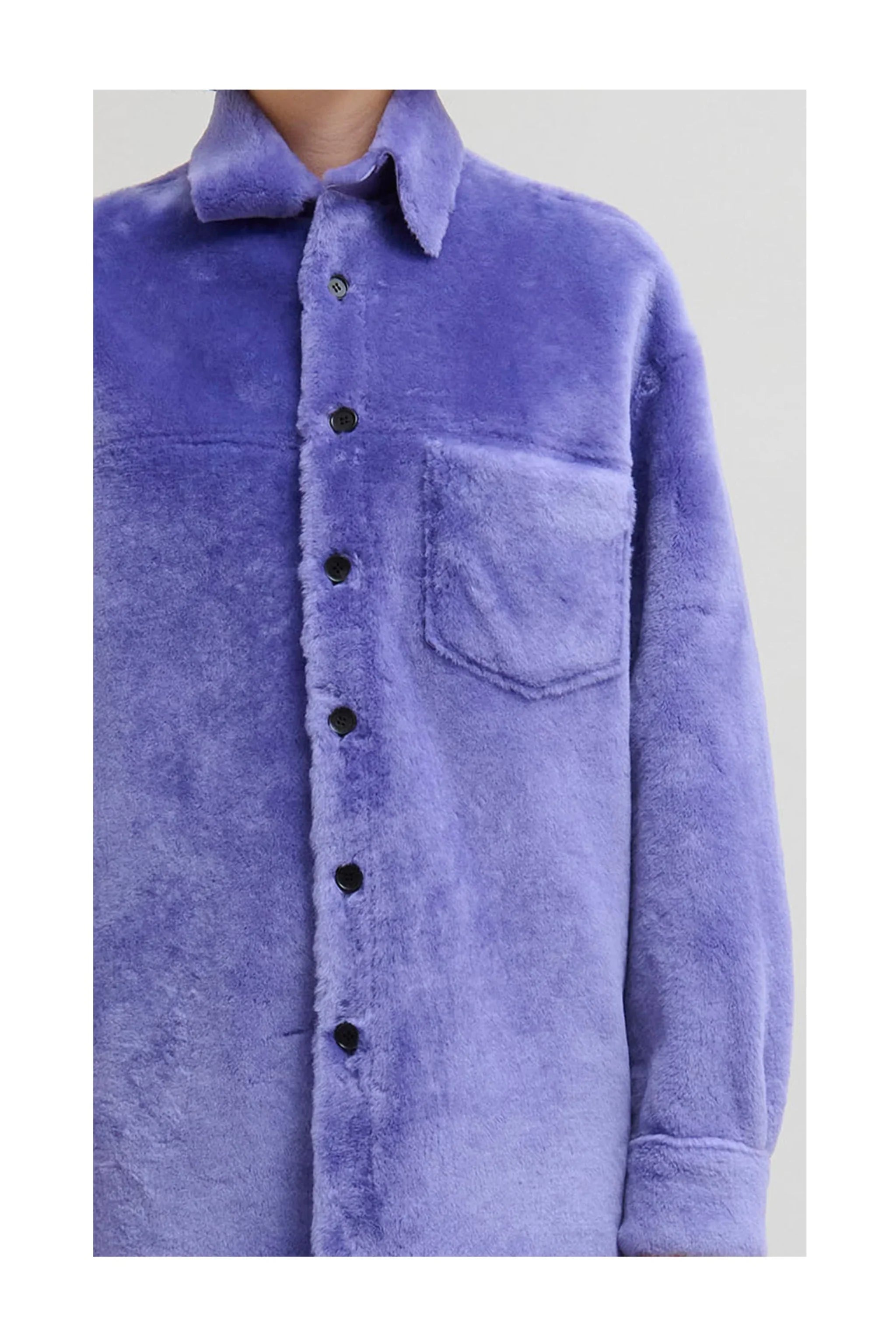 Close-up of purple plush button-up shirt with chest pocket and pointed collar