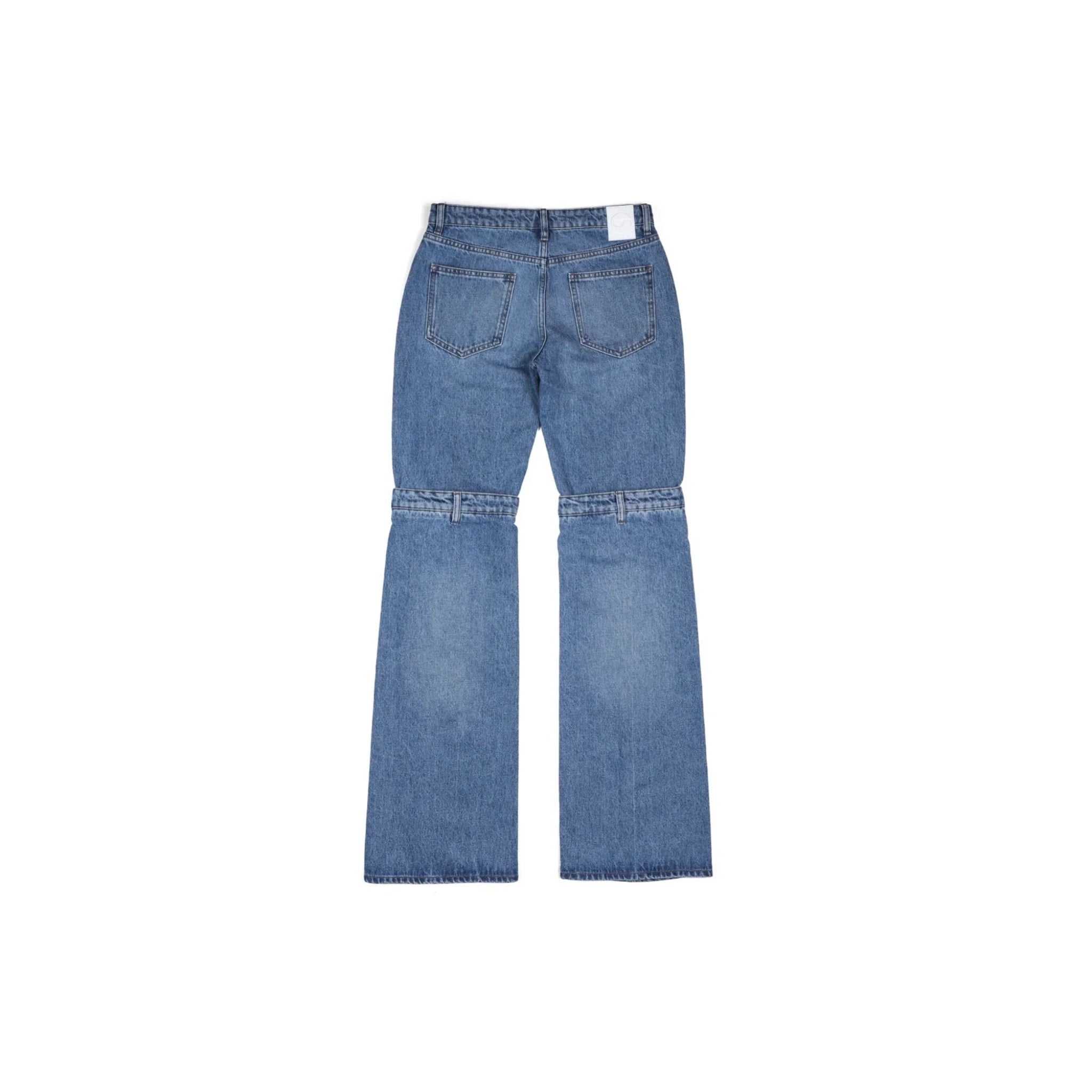Back view of blue denim jeans with zipper detail around knees on white background