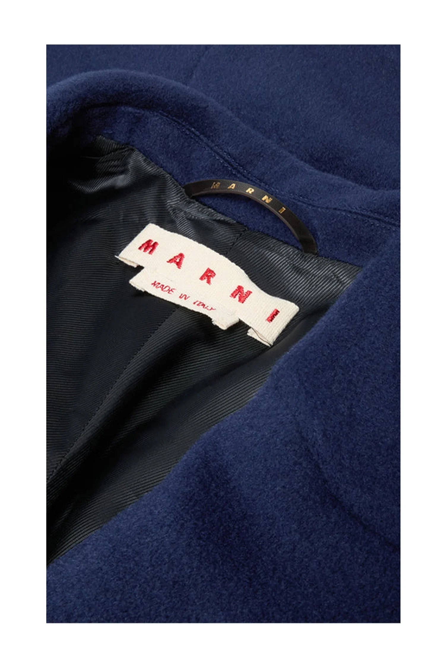 Close-up of navy blue wool coat collar with black lining and Marni brand label