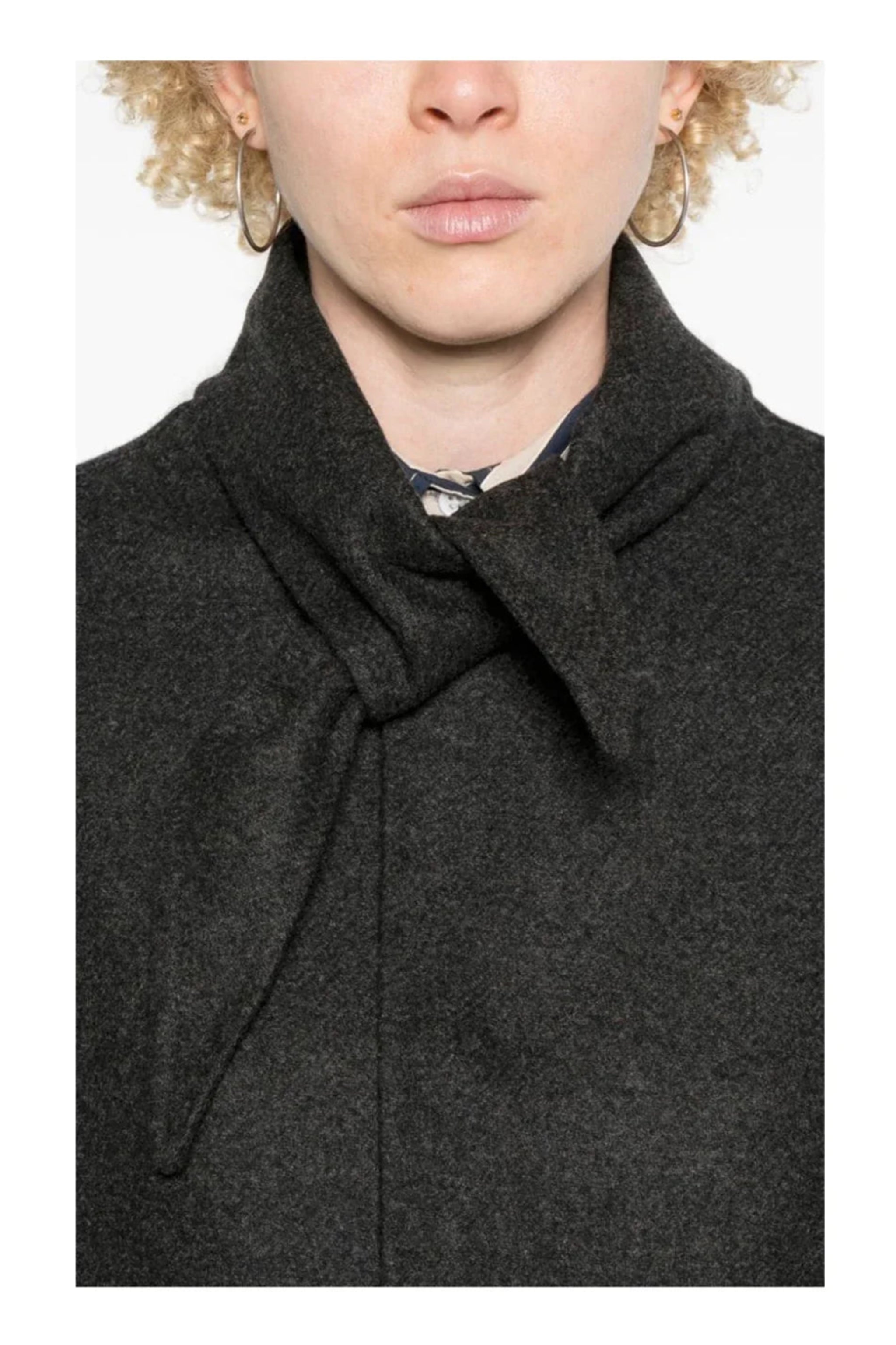 Person wearing a dark gray coat with a white background