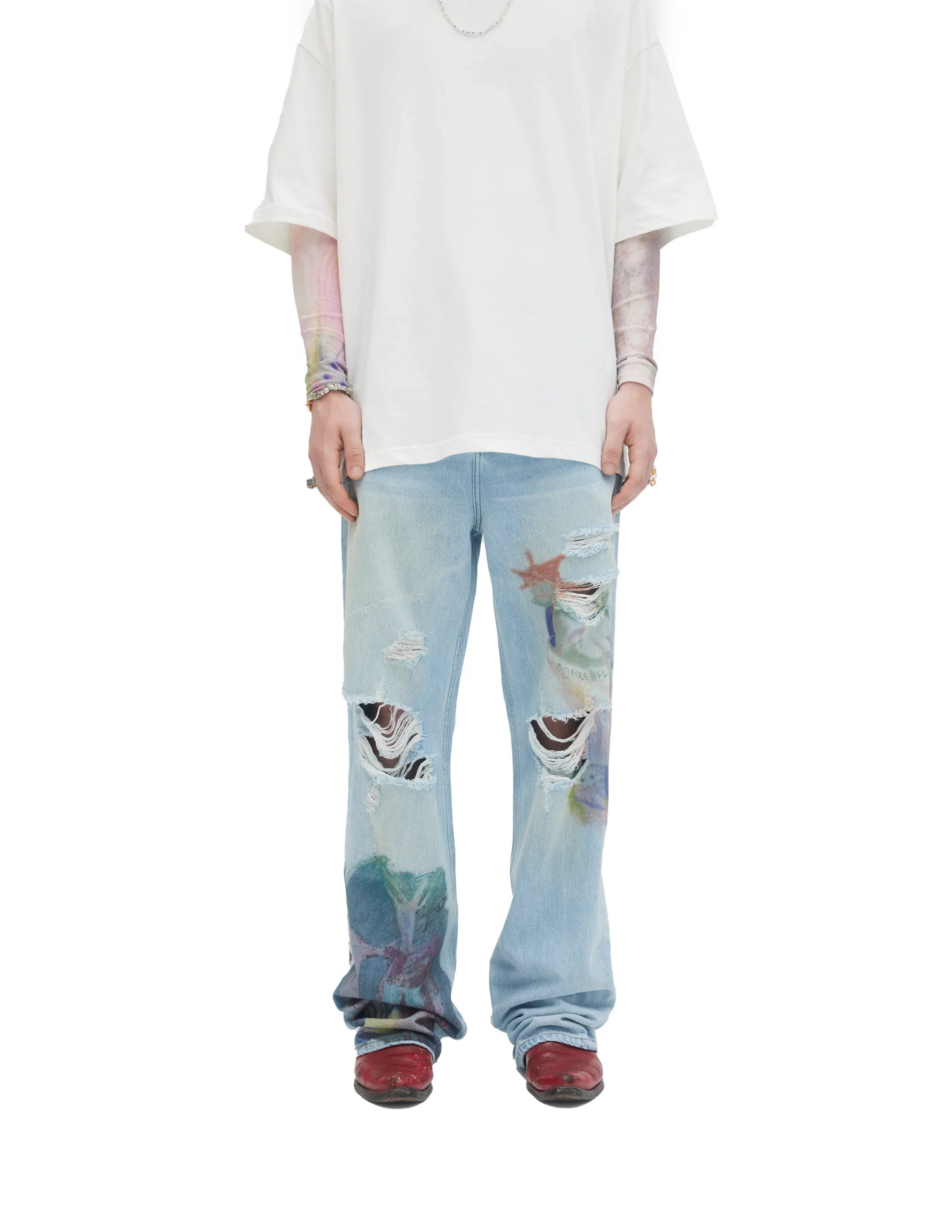 Front view of light blue distressed bootcut jeans with colorful paint splatters and tears