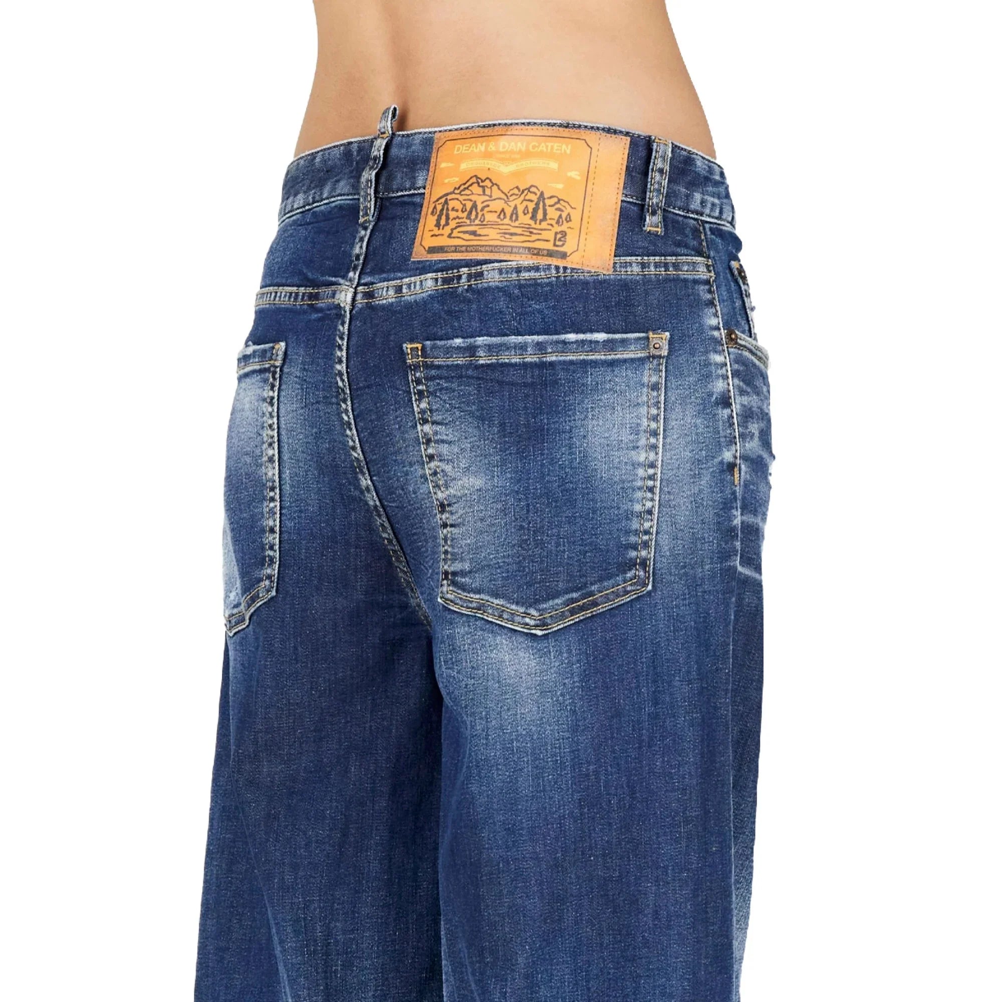 Back view of blue denim jeans with faded wash and leather brand patch on waistband