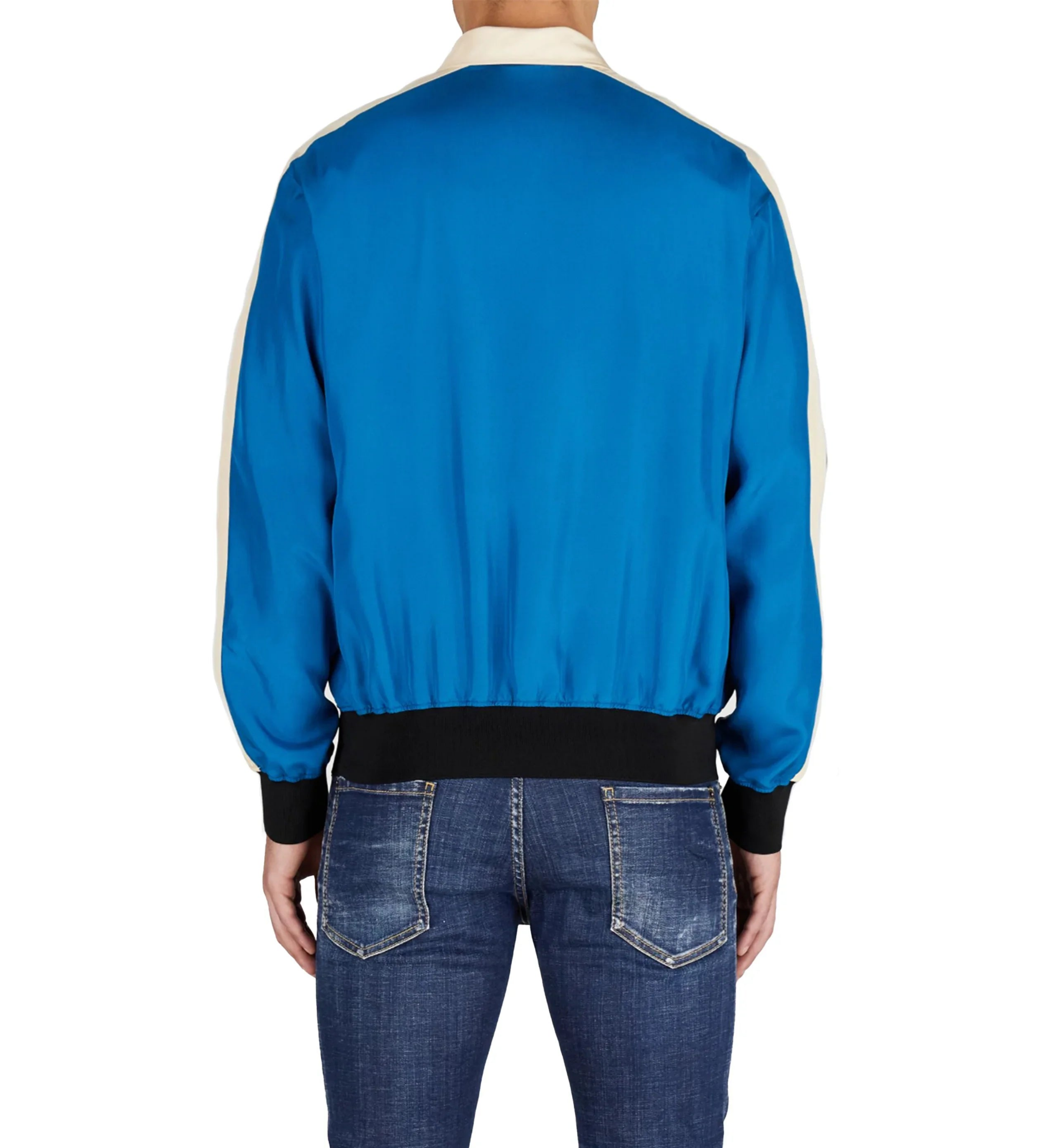Back view of man wearing blue satin bomber jacket with black cuffs and faded blue jeans