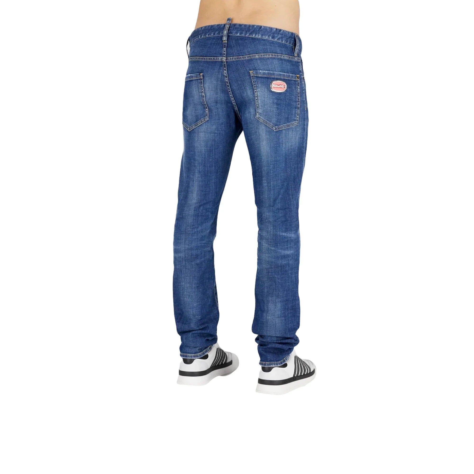 Rear view of person wearing blue denim jeans with back pockets and white sneakers on white background