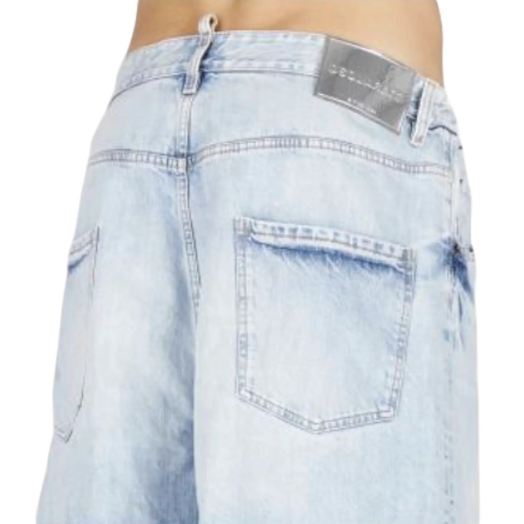 Close-up of light blue denim shorts with back pockets and brown leather patch label