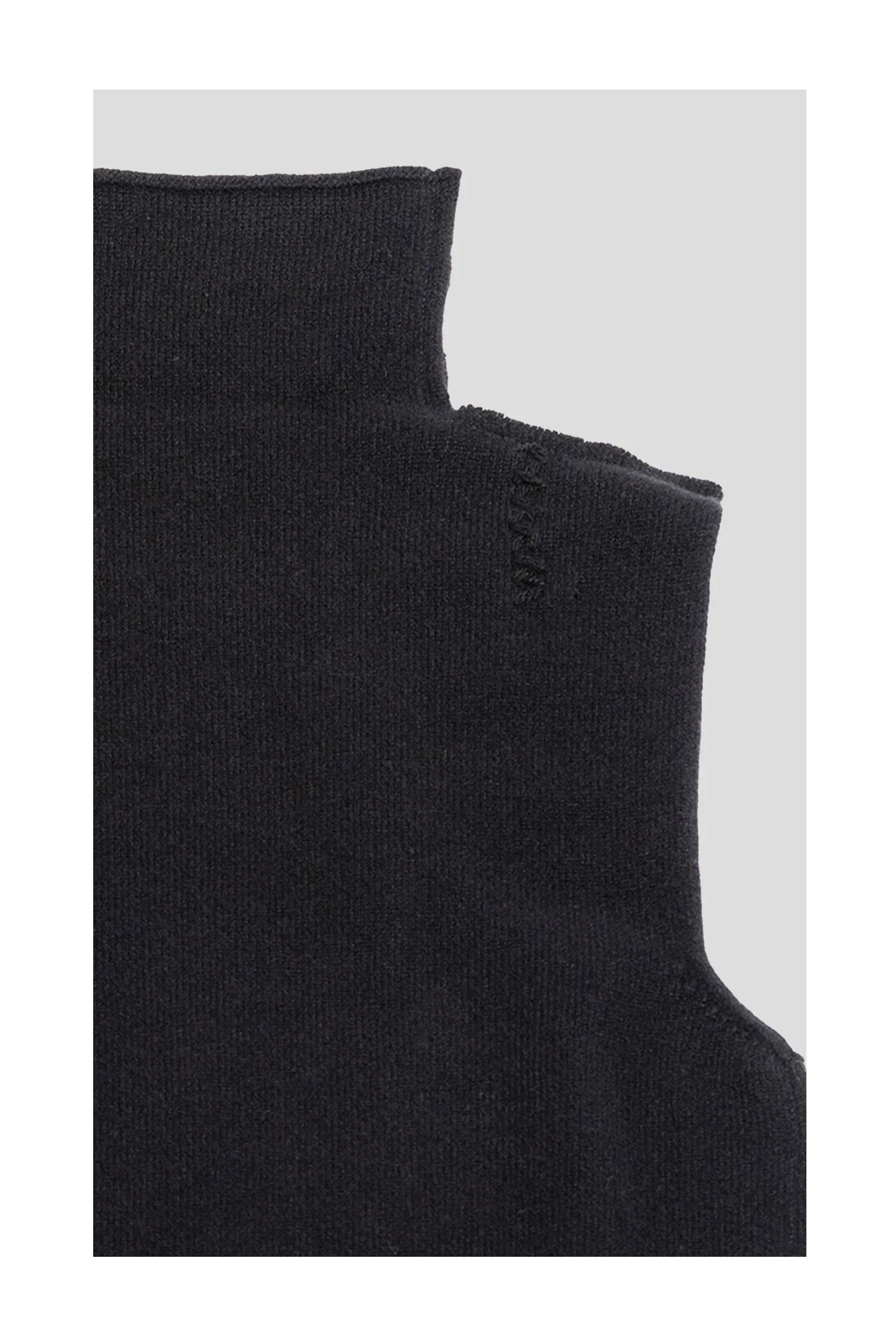 Close-up of black wool knit sweater with high neck and subtle stitching detail