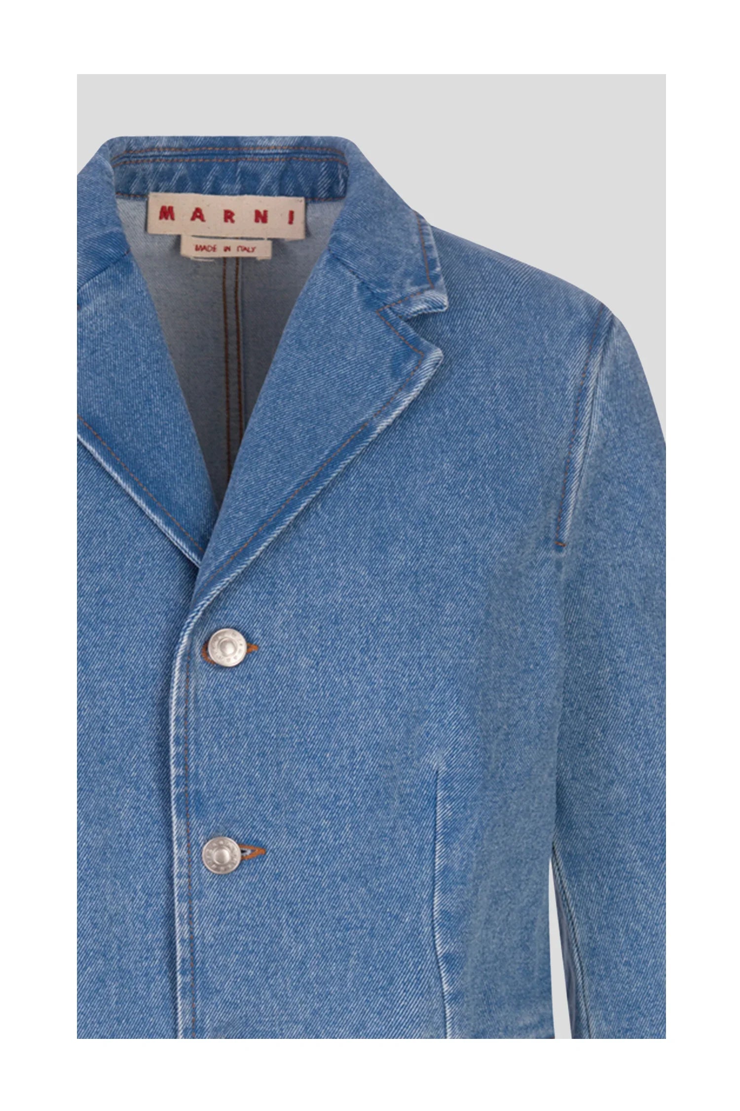 Close-up of a blue denim jacket with lapel collar and two silver buttons, Marni label