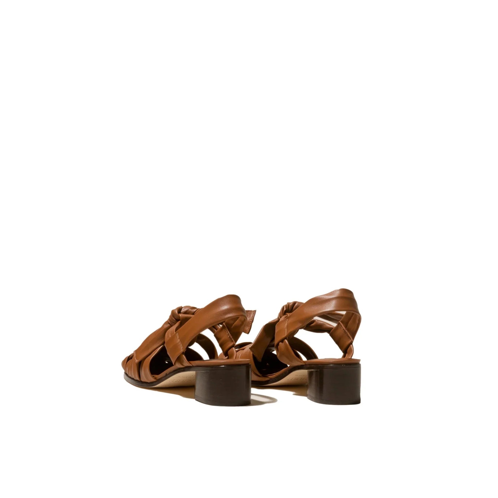 Brown leather heeled sandals with an open back and braided straps on white background