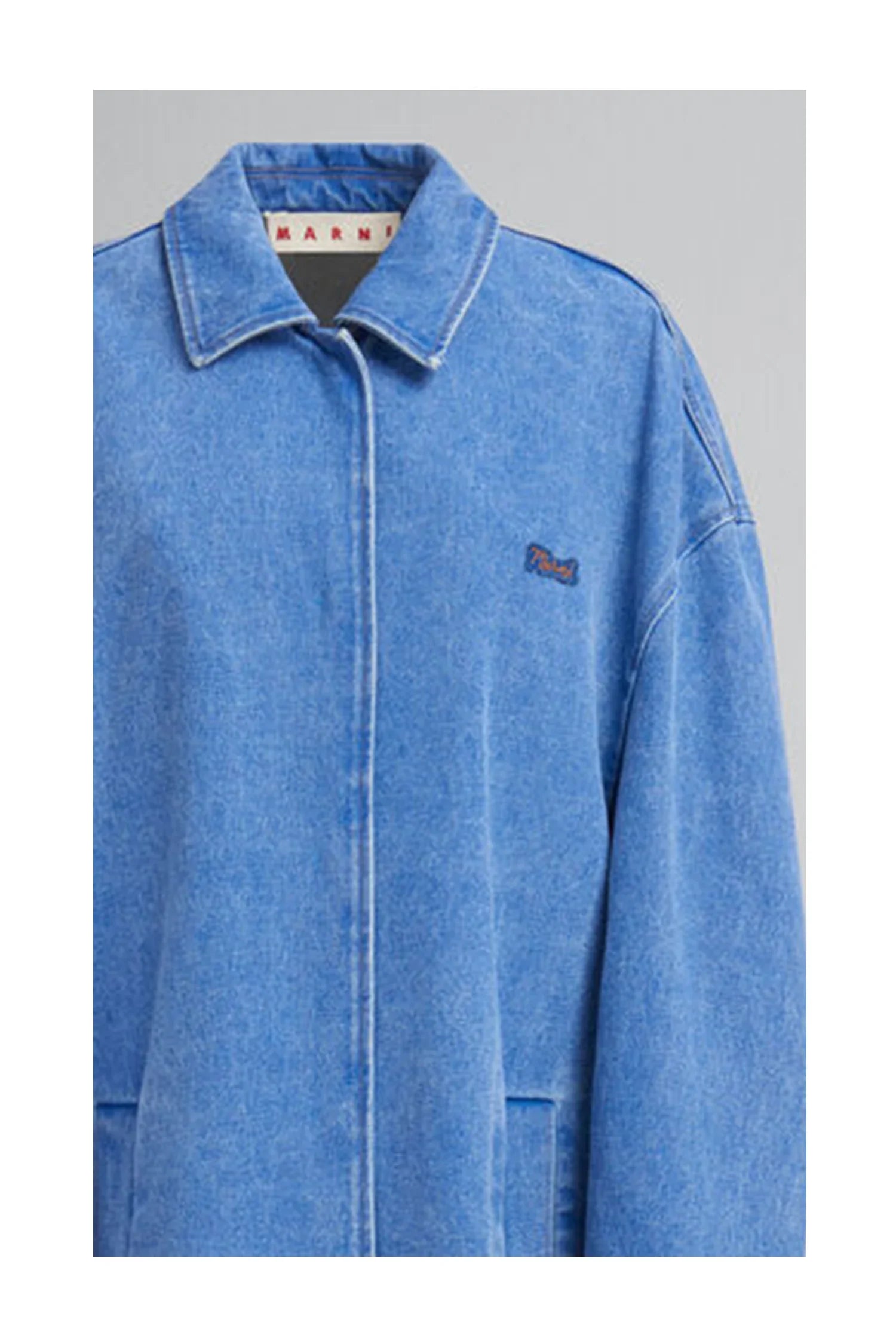 Light blue denim jacket with collar and front pockets, featuring small embroidered logo on chest