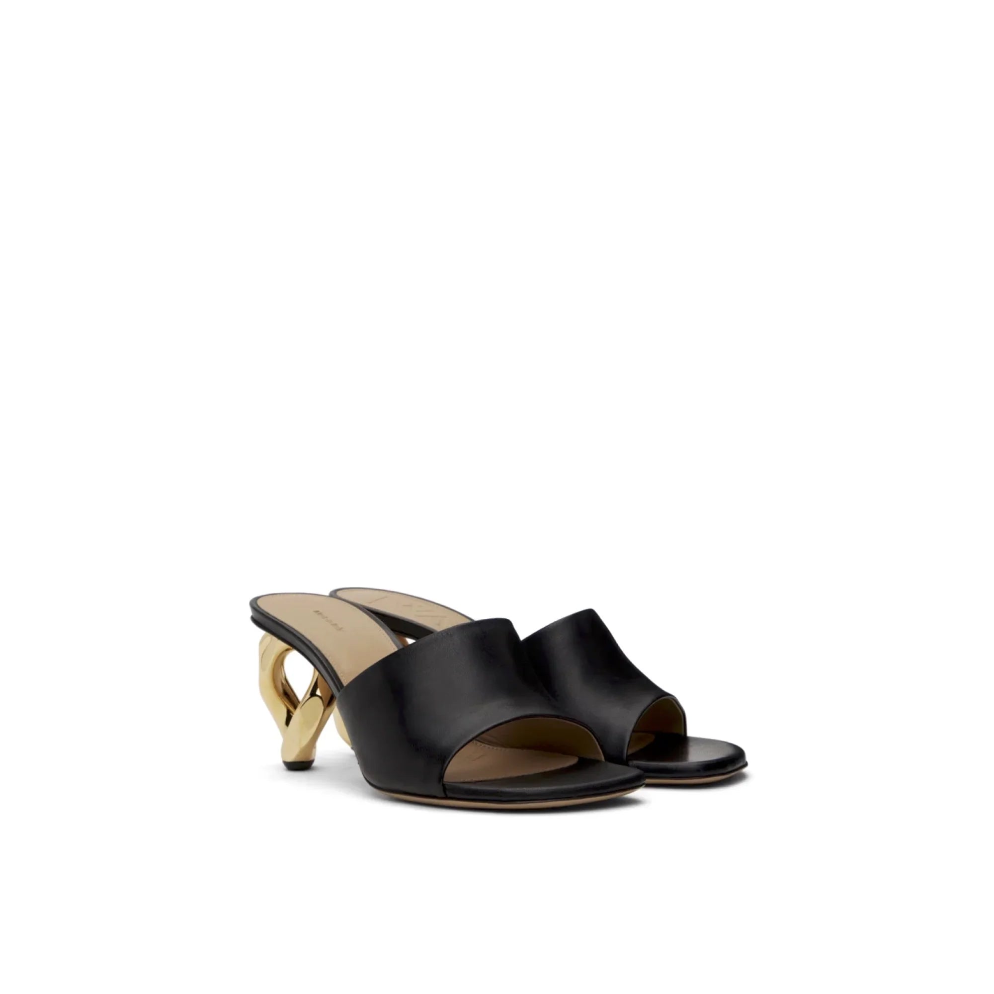 Black leather mule sandals with twisted gold chain heels on white background