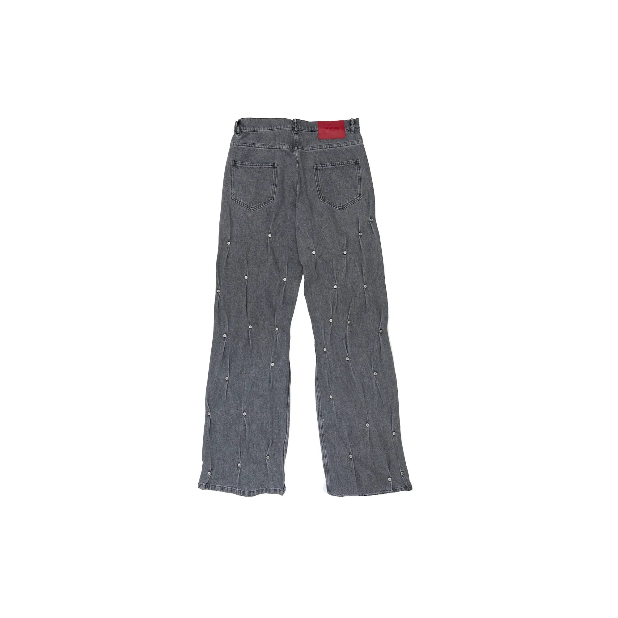 Back view of gray denim jeans with pearl embellishments and red logo patch on waistband