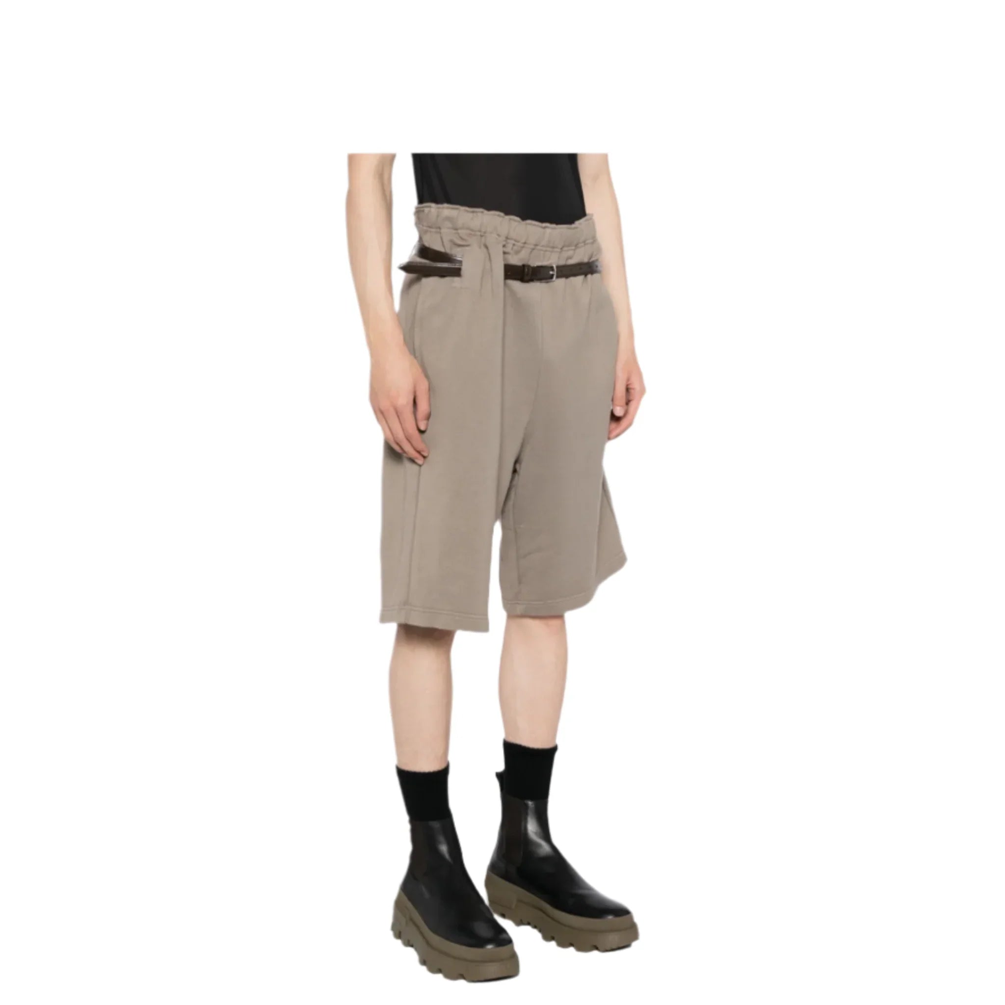 Model wearing taupe paperbag waist athletic shorts with black belt, black socks, and chunky black boots