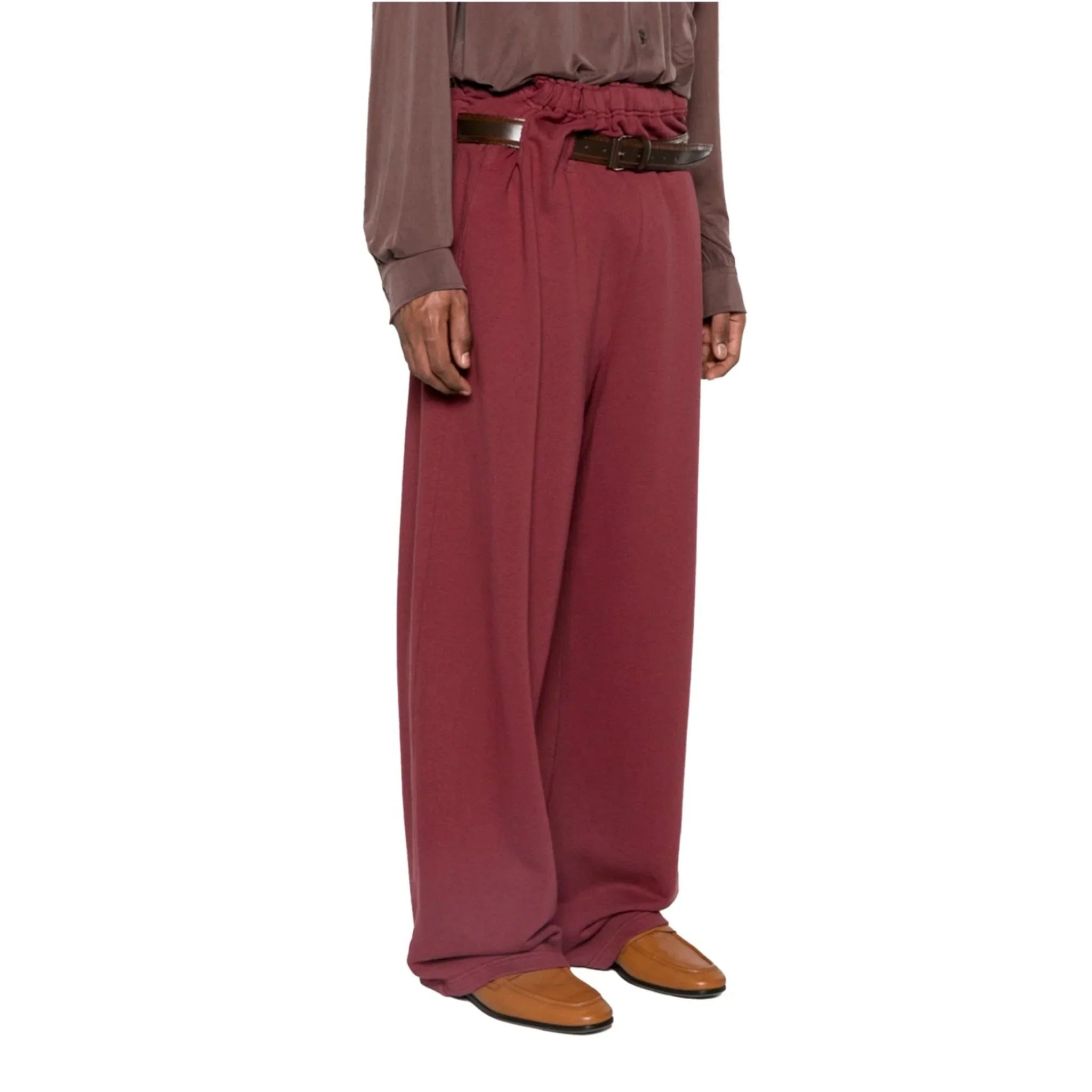 Model wearing wide-leg mauve trackpants with high elastic waist belt and brown loafers