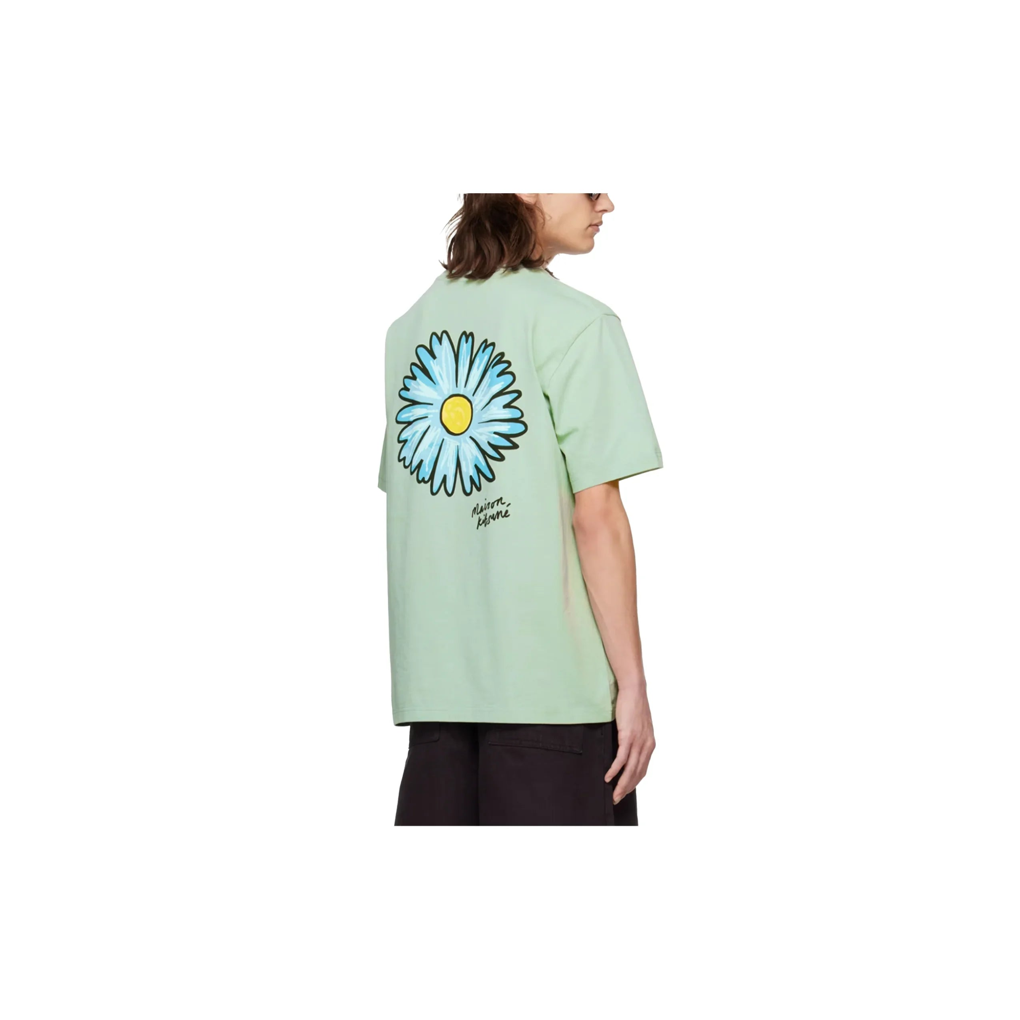 Person wearing light green Maison Kitsuné T-shirt with large blue flower print on back