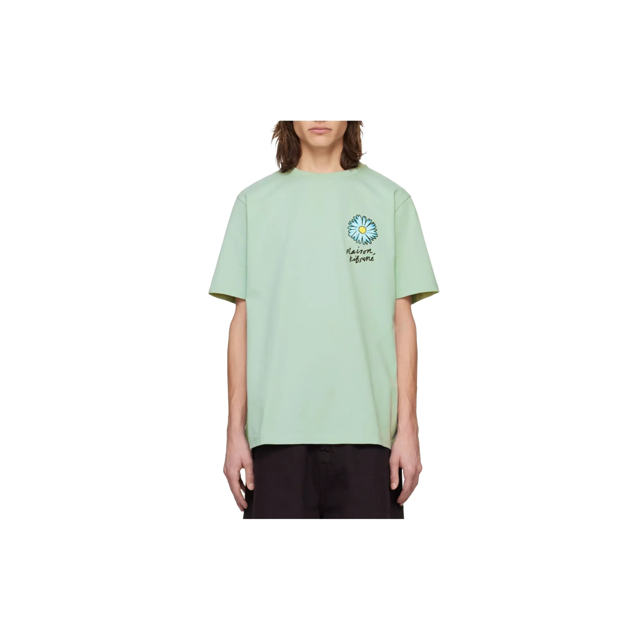 Front view of person wearing pastel green Maison Kitsuné t-shirt with blue daisy flower and logo