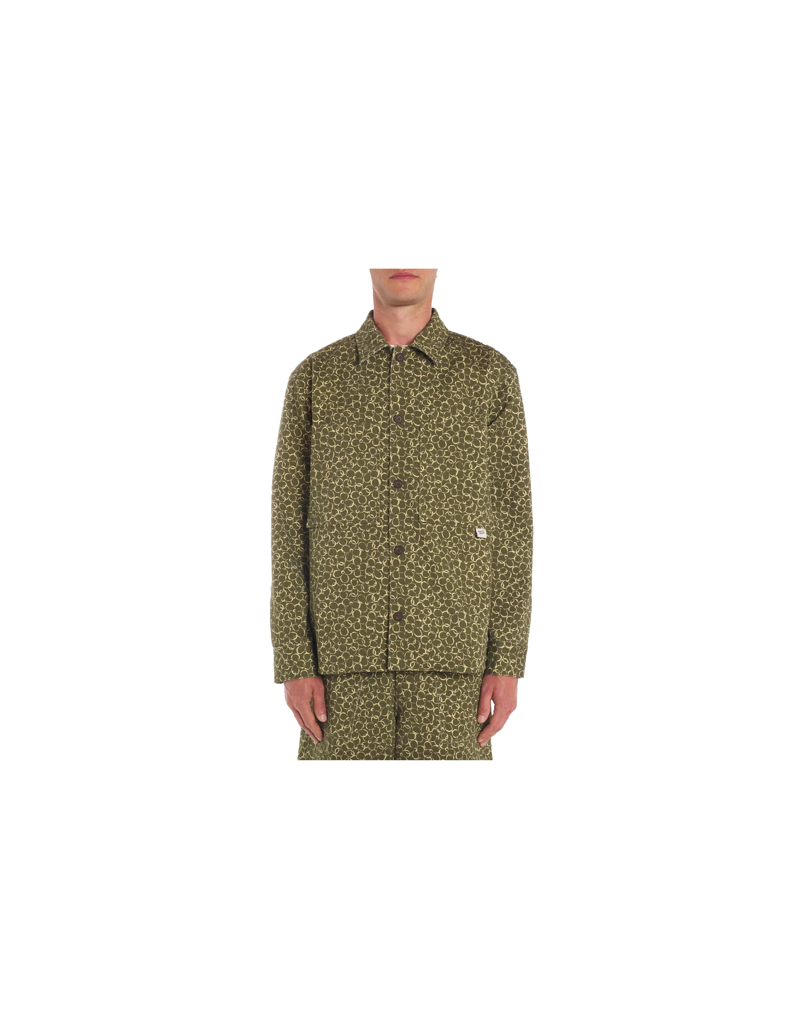 Front view of a man wearing olive green patterned button-up jacket and matching pants