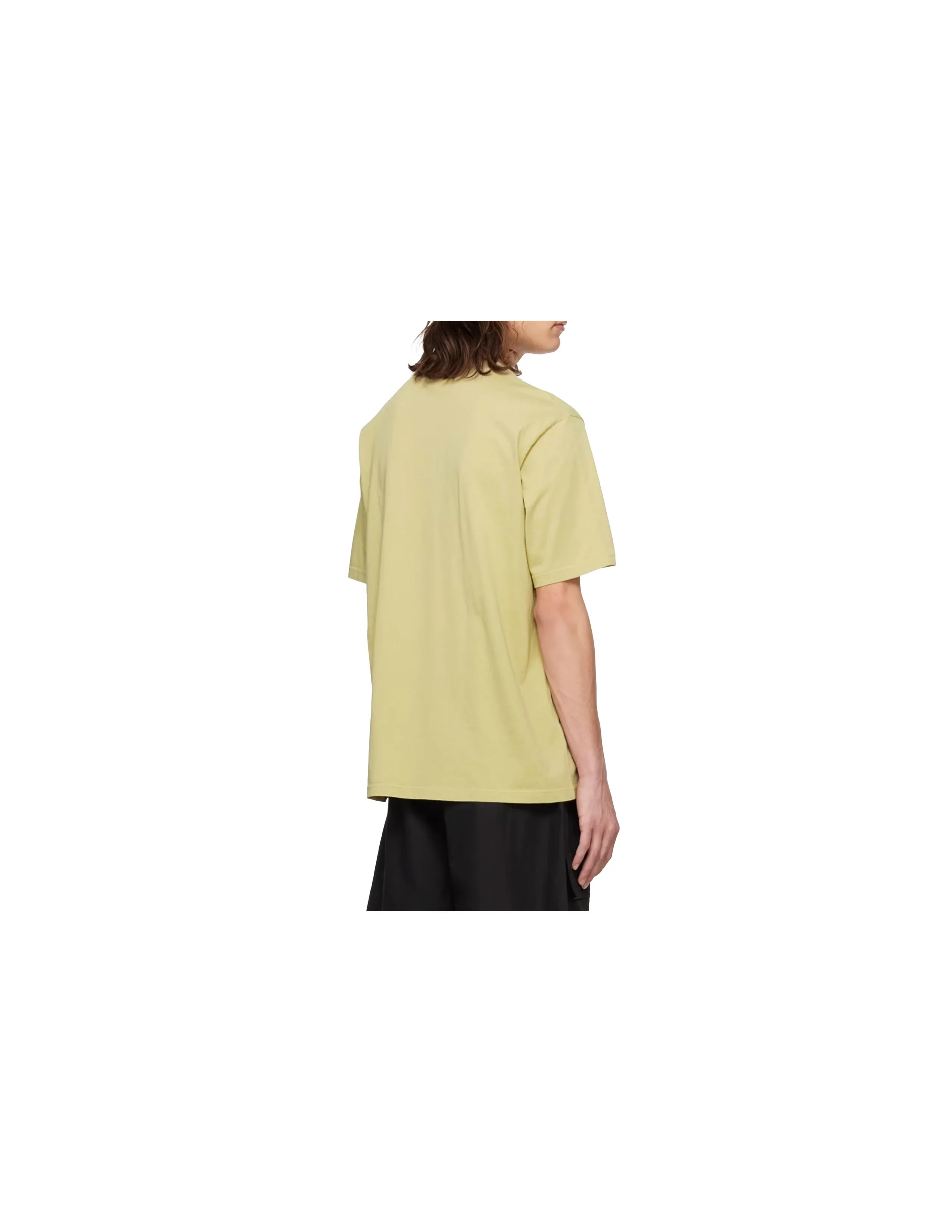 Back view of person wearing light green short sleeve t-shirt and black pants