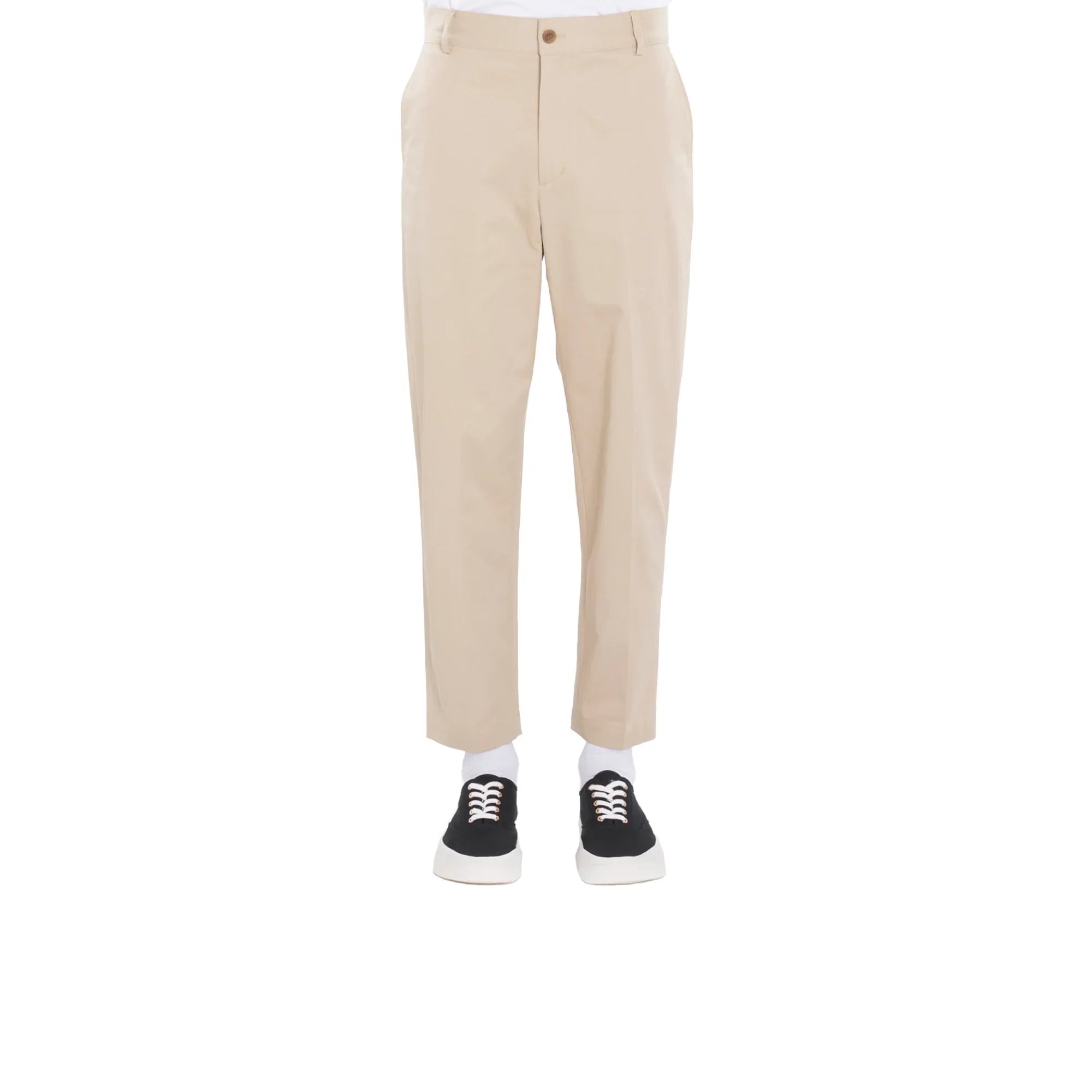 Beige straight chino pants worn with white socks and black sneakers on a white background