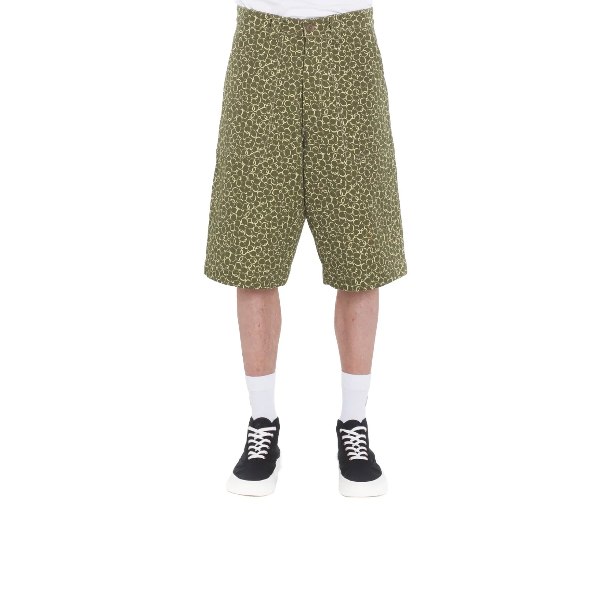 Men's green patterned workwear Bermuda shorts paired with white socks and black sneakers