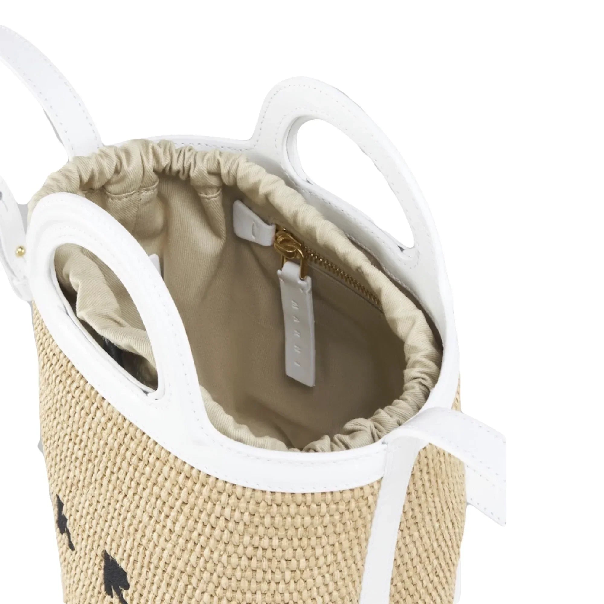Close-up of beige woven basket bag with white leather trim and beige fabric drawstring interior
