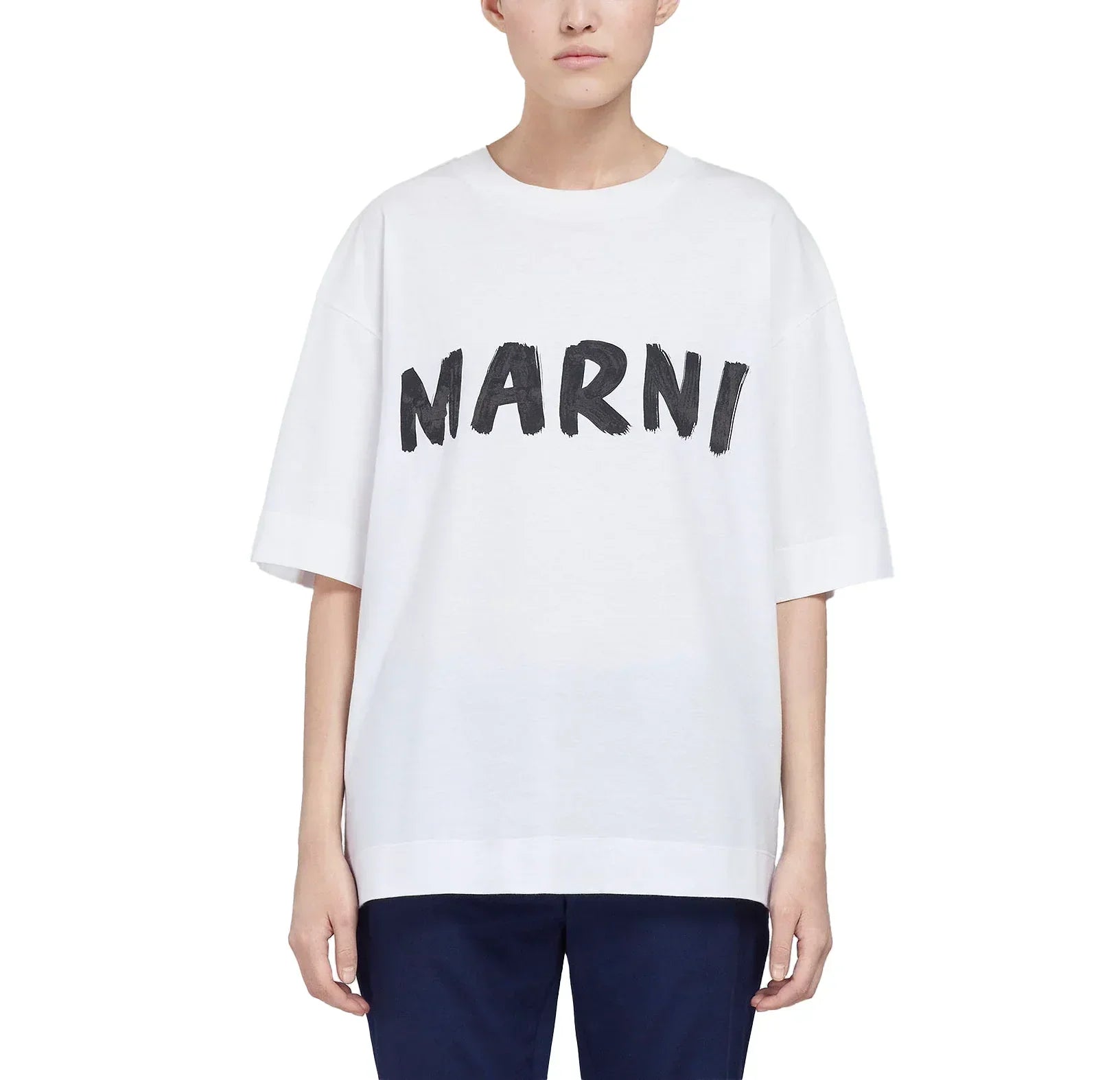 White oversized T-shirt with bold black MARNI logo, styled with dark pants on model