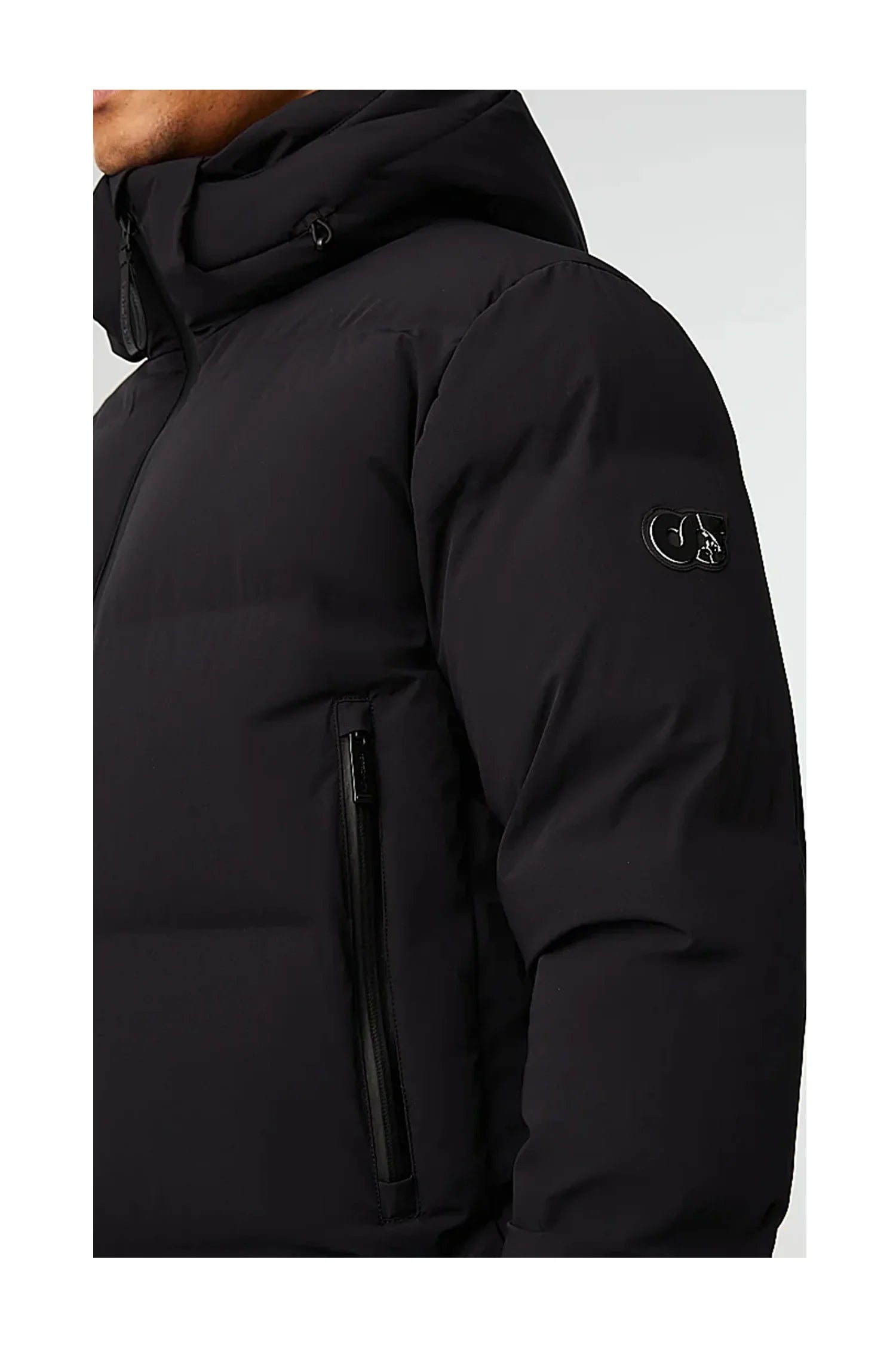 Close-up of a man wearing a black padded winter jacket with a hood and zippered side pocket