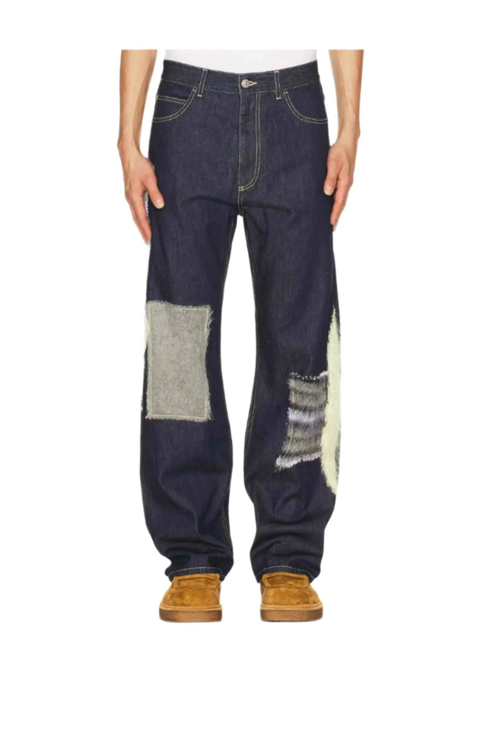 Men's dark denim jeans with large gray and striped fabric patches on legs