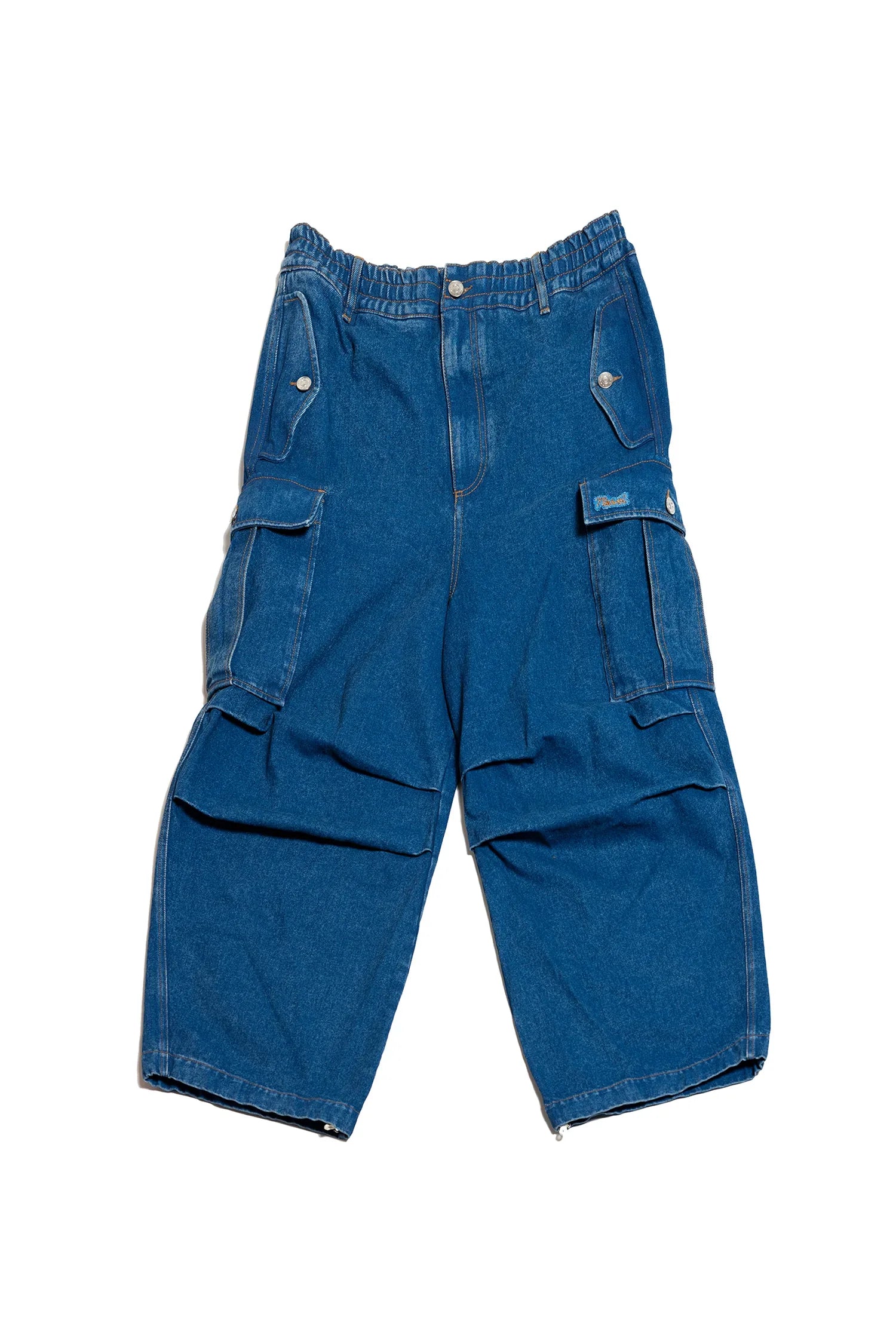 Blue denim cargo pants with multiple buttoned pockets and elastic waistband
