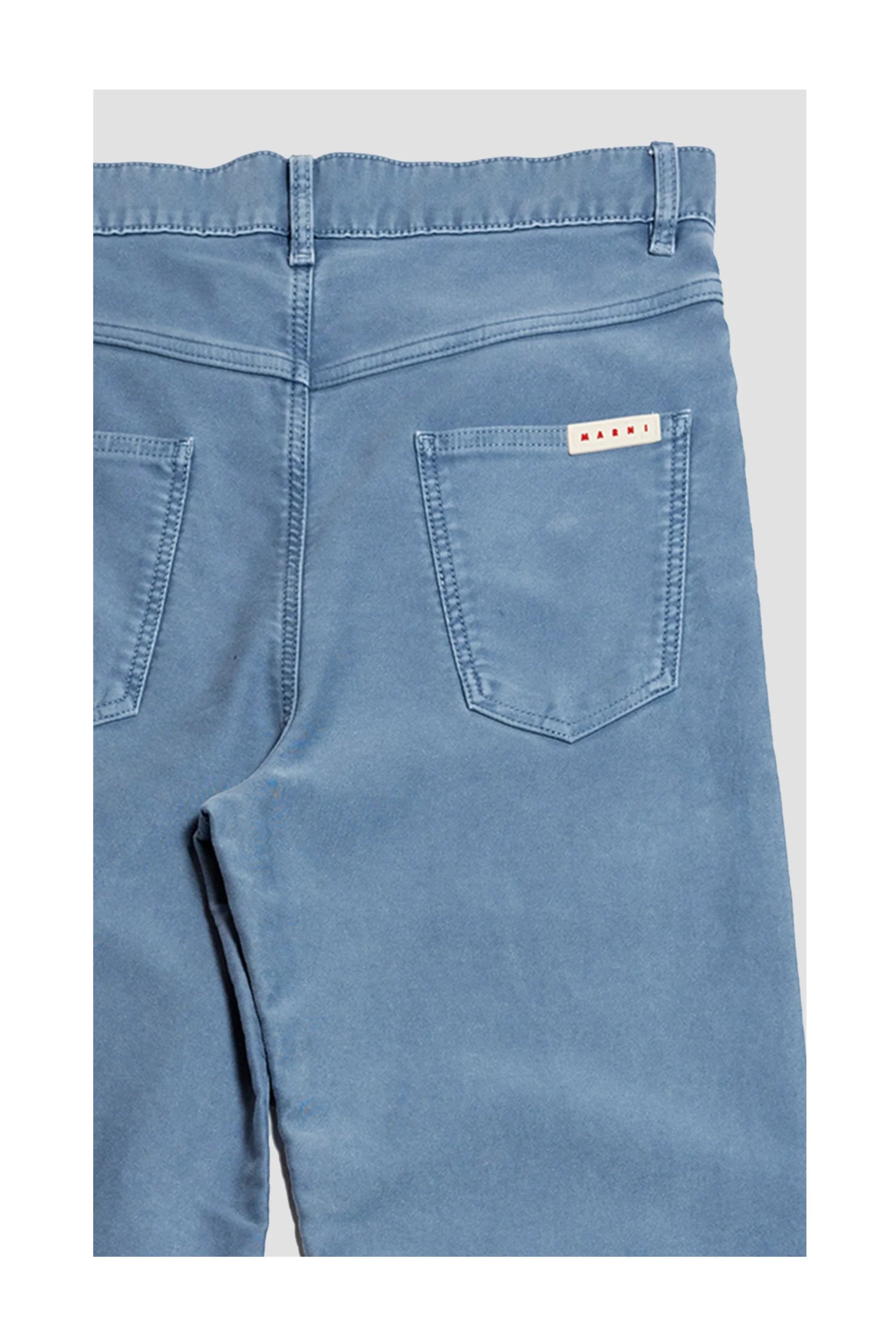 Back view of light blue denim jeans with two pockets and Marni brand label on right pocket