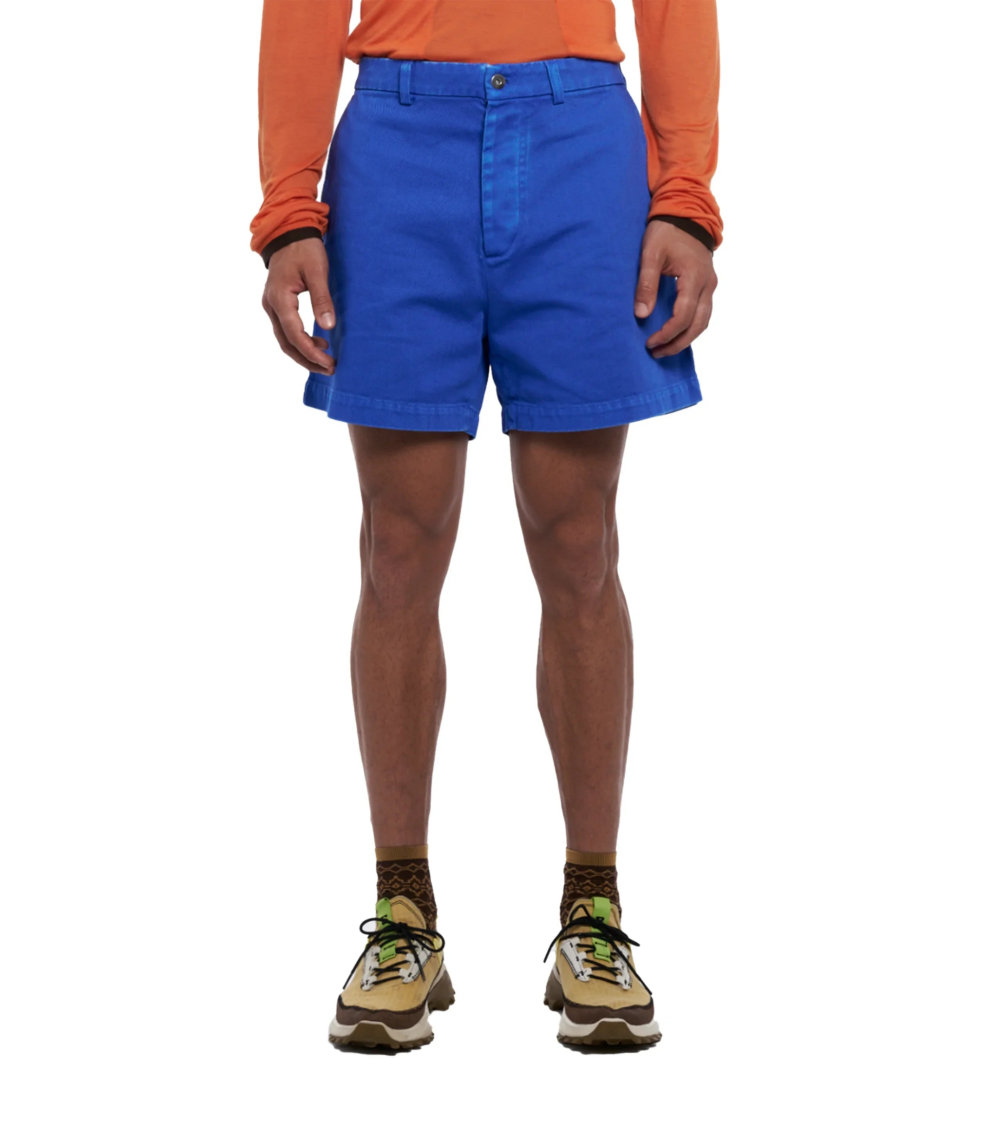 Men's blue casual shorts worn with orange long-sleeve shirt and brown lace-up sneakers