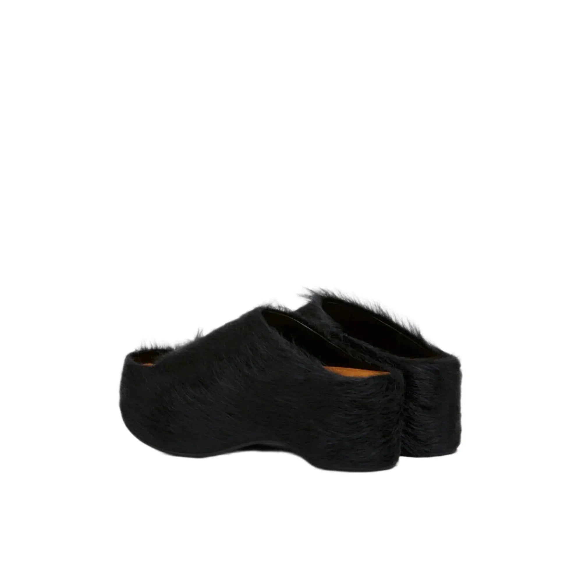 Black fur-covered platform clog shoes on white background