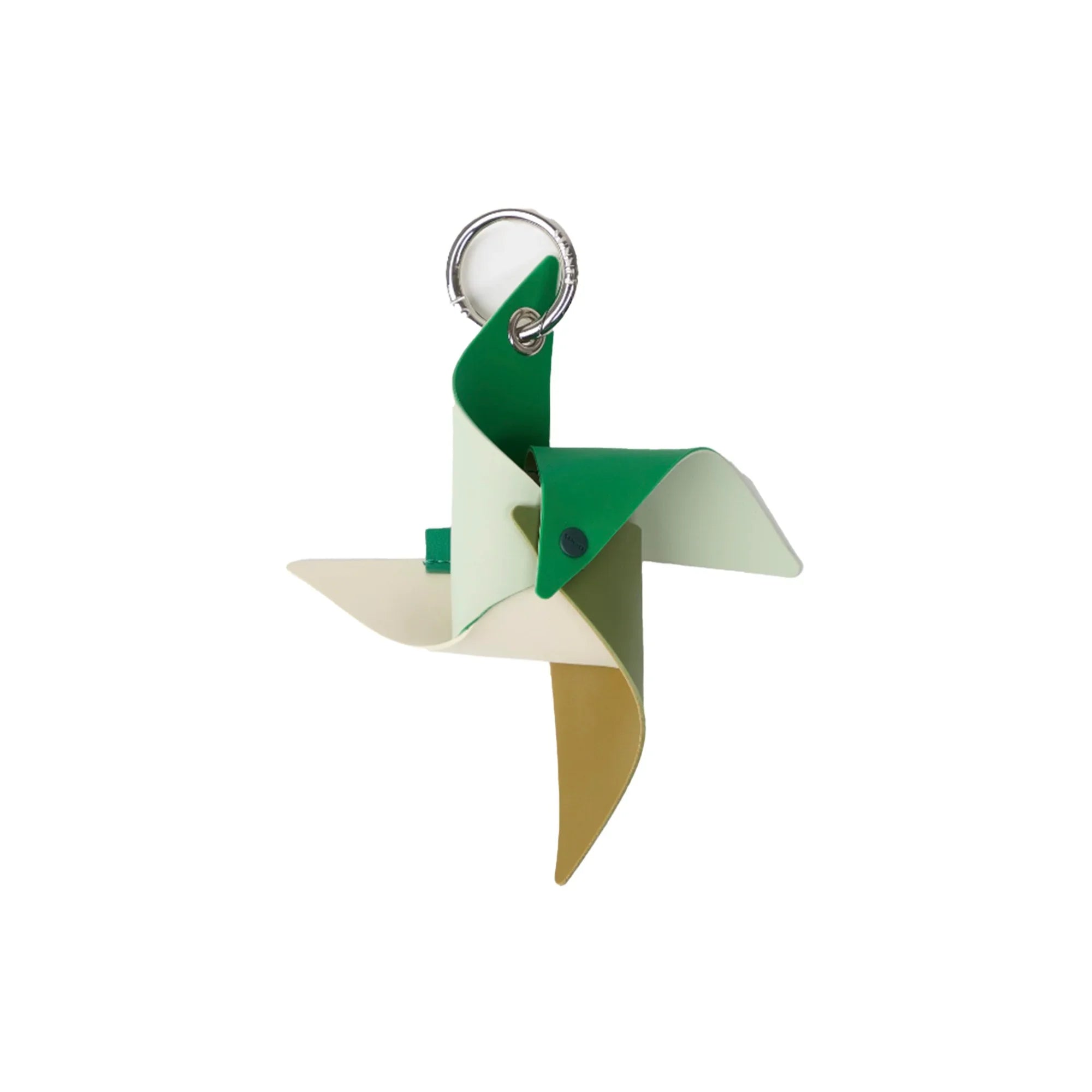 Green and beige leather pinwheel keychain with silver keyring on white background